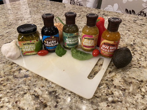 A line of five different Bazodee hot sauces