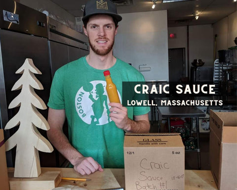 Brian of Craic Sauce Holding Up A Bottle of Hot Sauce