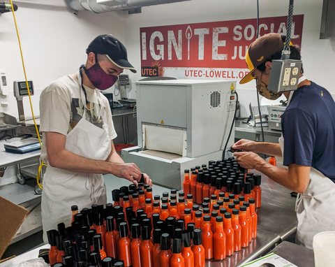 Craic Sauce Team Working on Mill City Red Bottles in the Kitchen