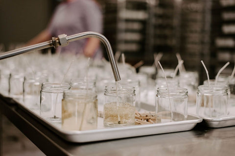 Behind the scenes of pouring clear jar soy wax candles from Sweet Water Decor