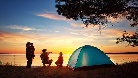 Family on a camping trip watching the sunset