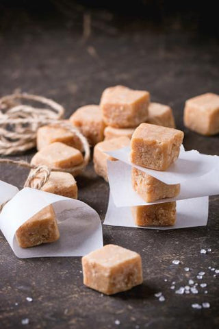 Stacks of Scottish Tablet Cubes wrapped in parchment paper