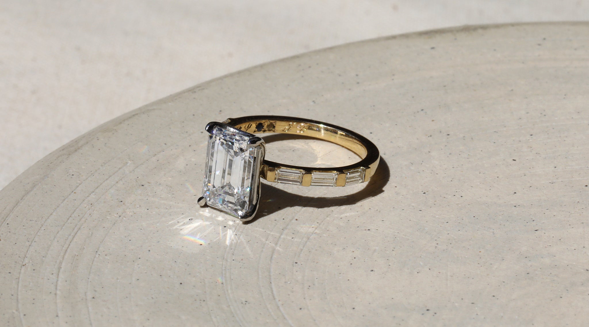 Bespoke diamond engagement ring with engraving and secret stones set inside the band.