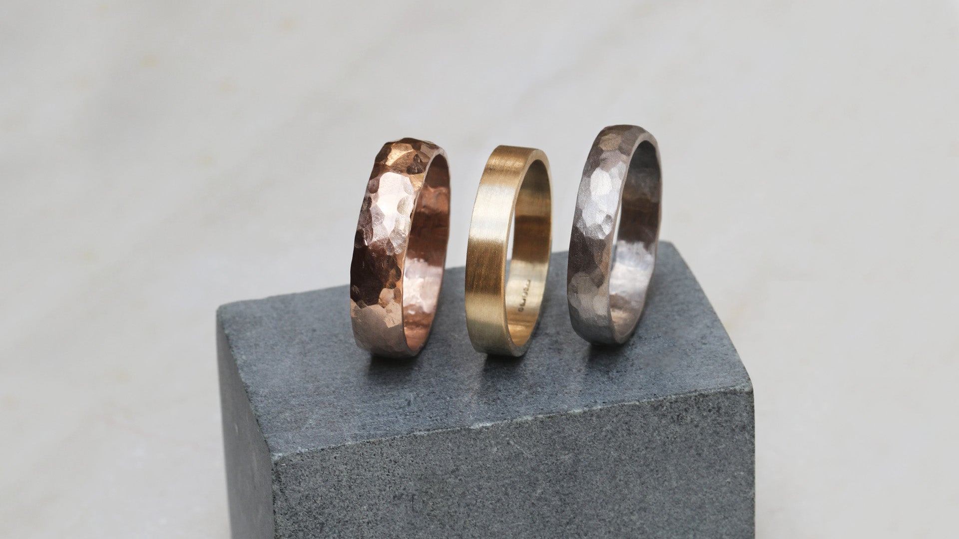 Our Mens Wedding Bands pictured in 18ct Red, Yellow and White Gold, in a variety of finished - from high polish to hammered matte finish. We create custom wedding bands to suit your personal style.