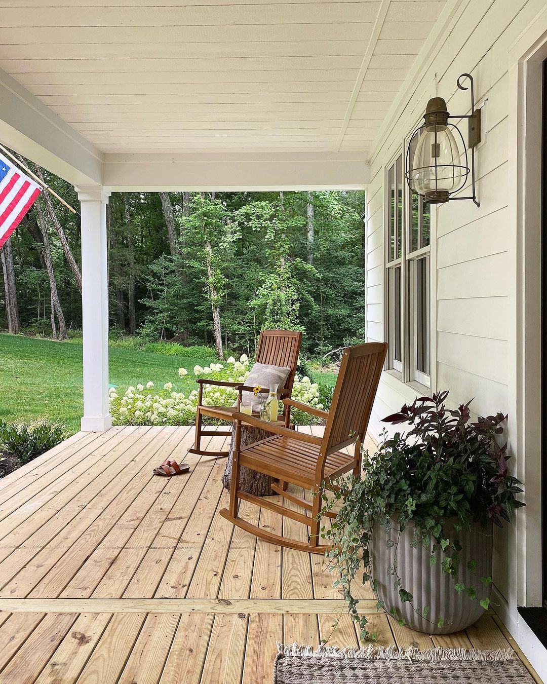 porch with chairs and a table and the American flag