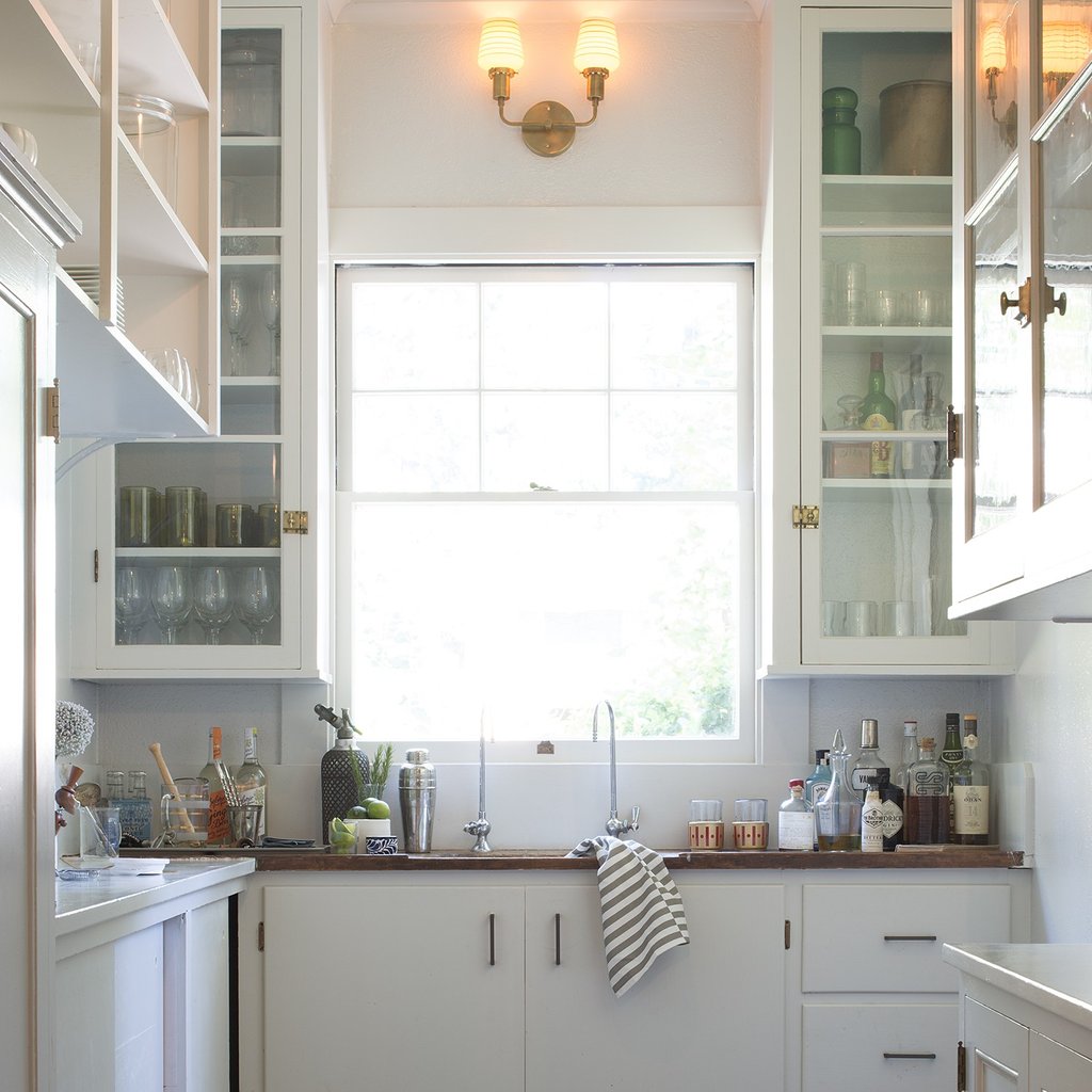 kitchen with white cabinets and a large window