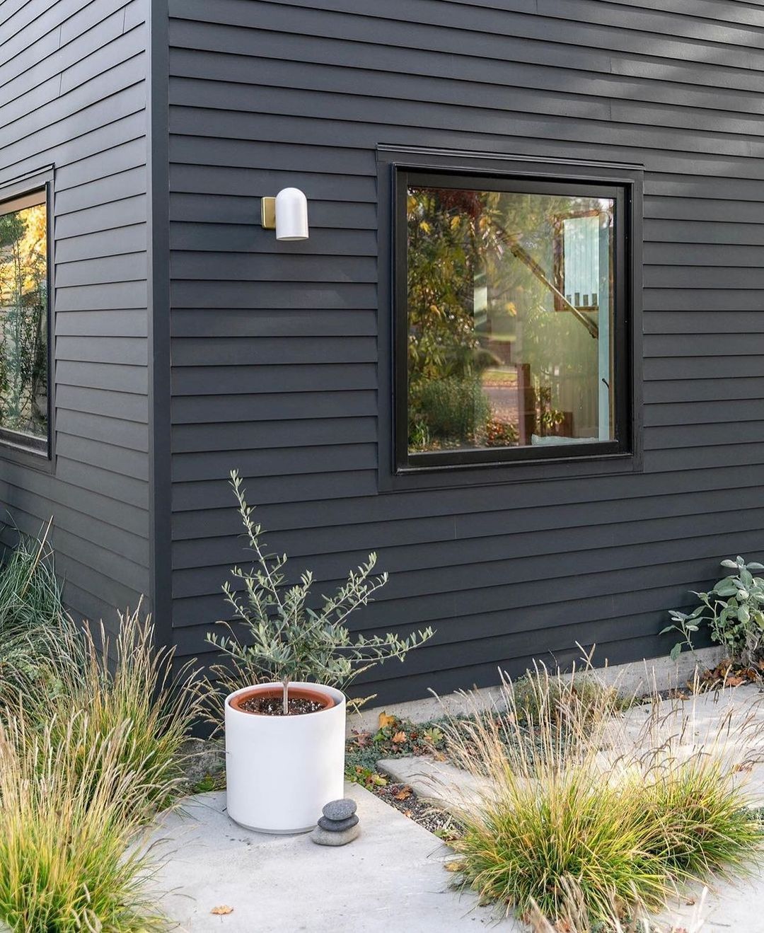 black house with a planter outside