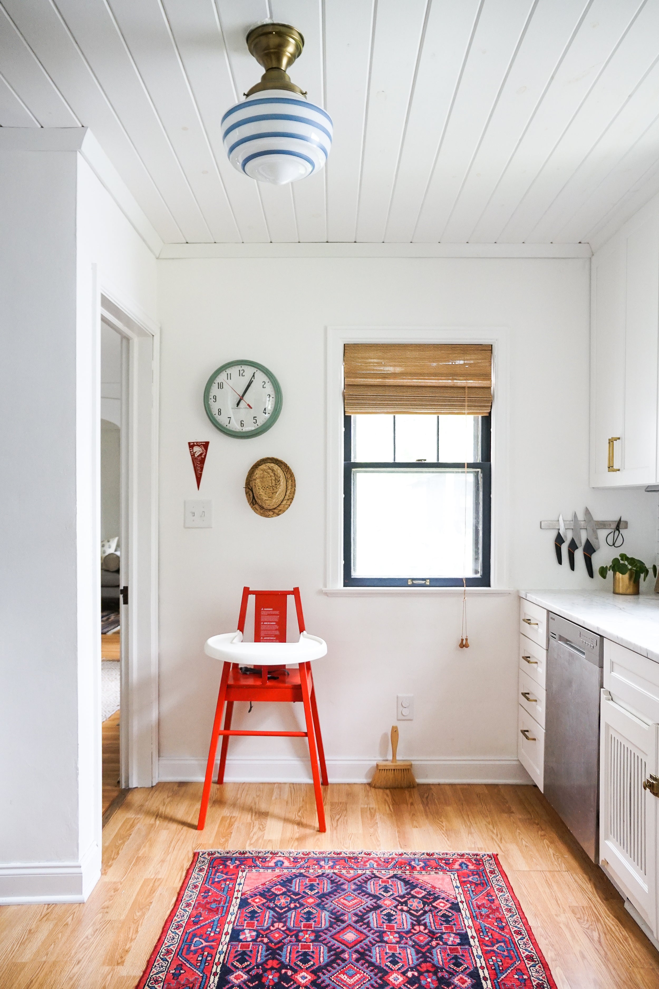 clock on a wall and red chair