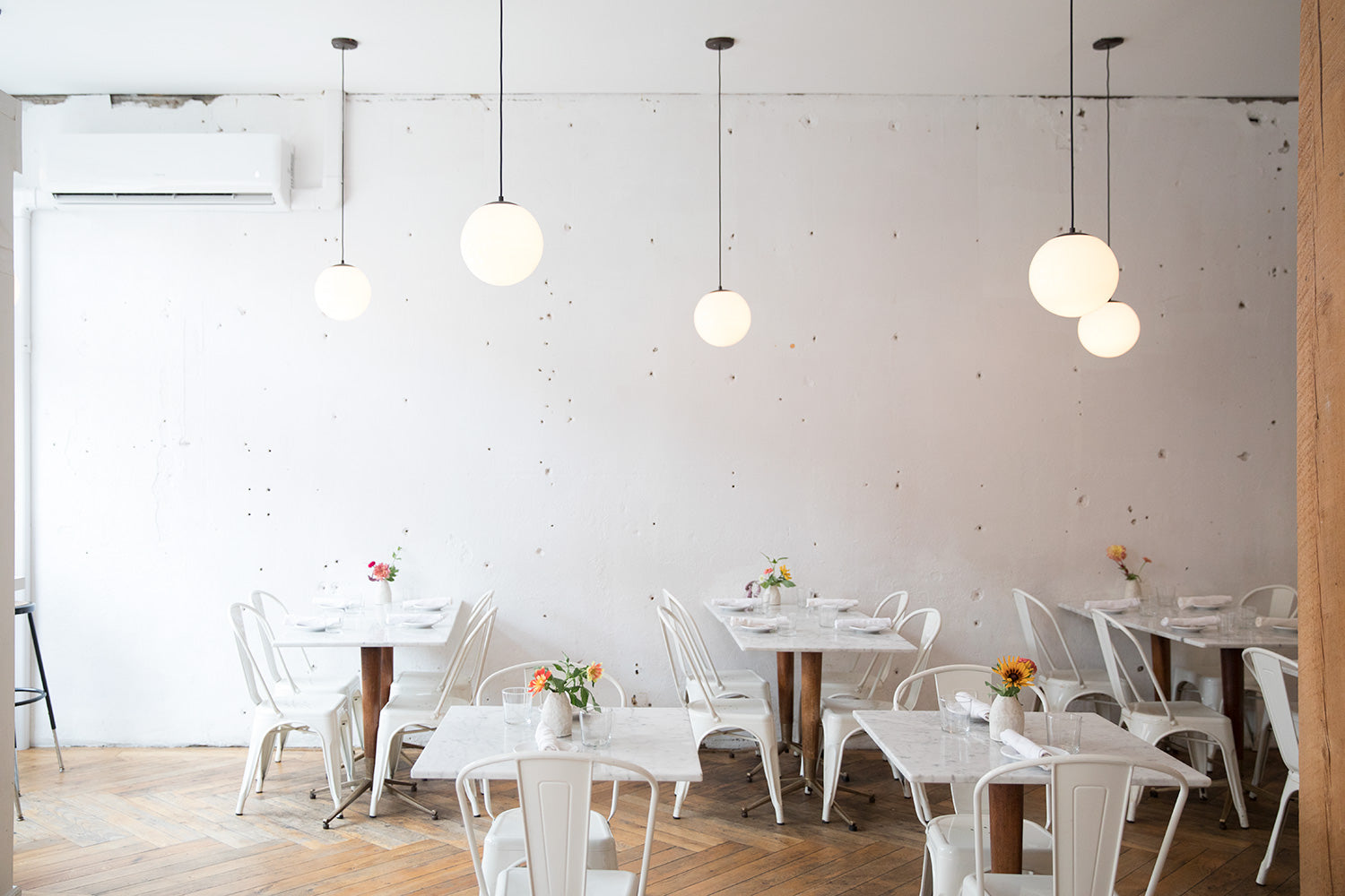 room with tables and chairs and ceiling light fixtures