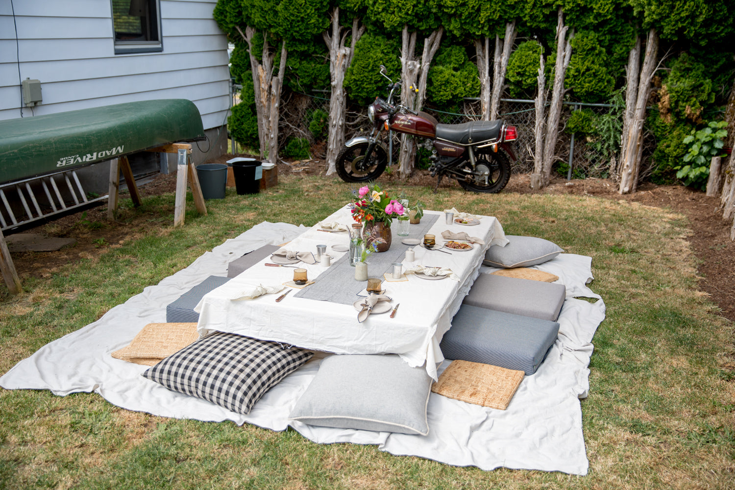 picnic blanket with pillows and a low table