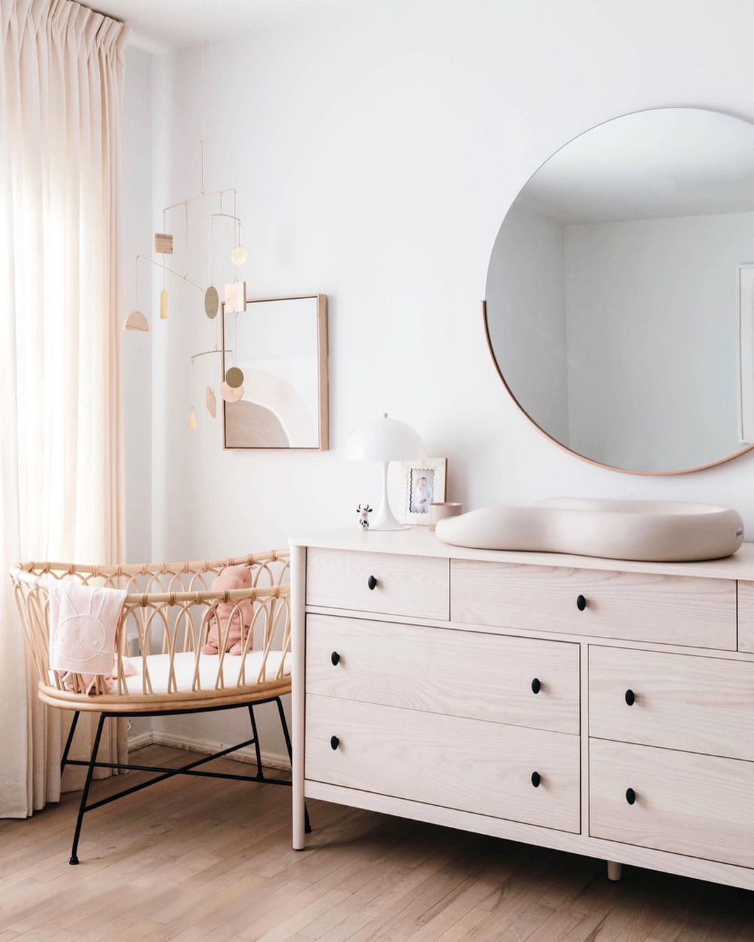 bedroom with crib and dresser and mirror