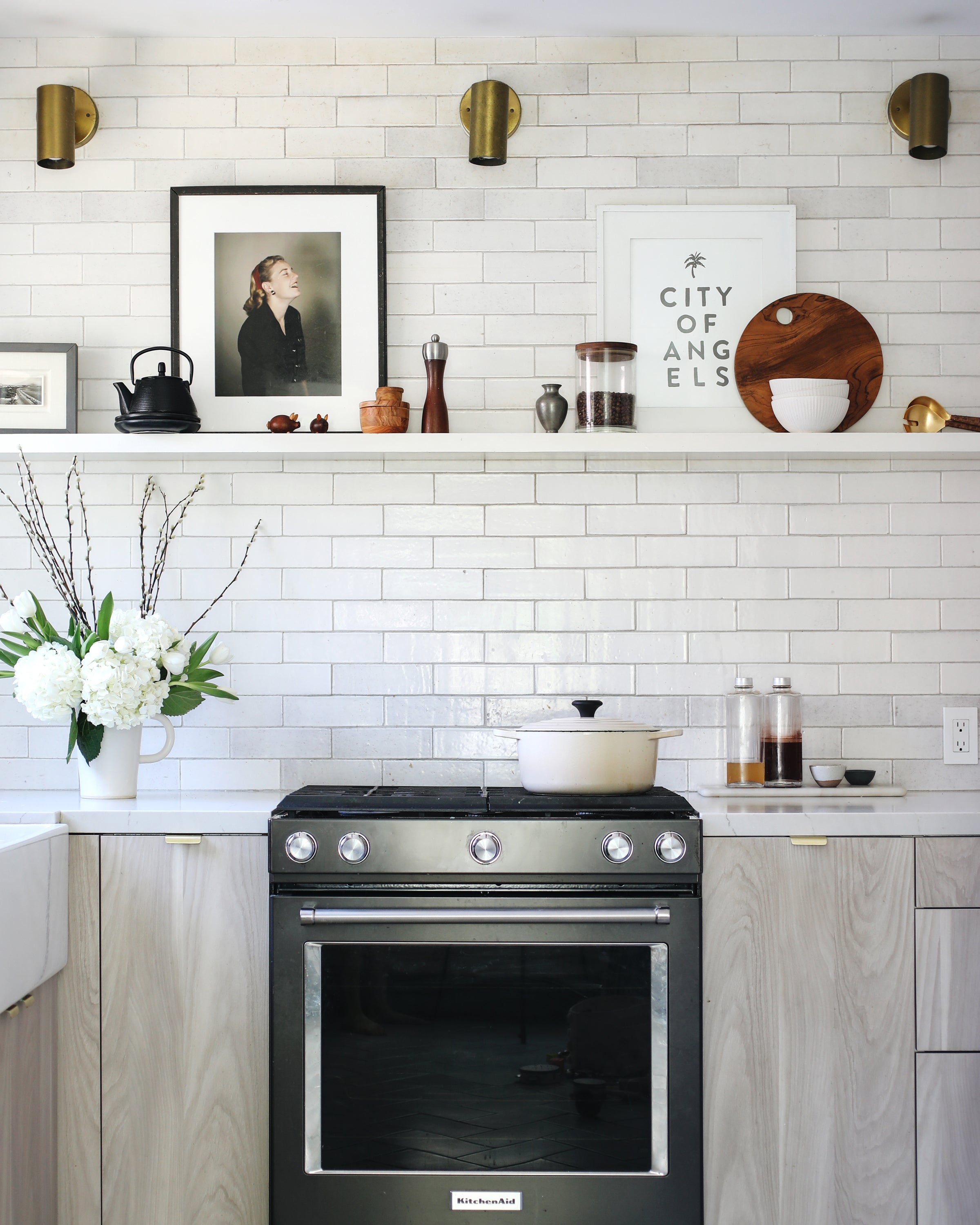 kitchen with a stove and white shelves