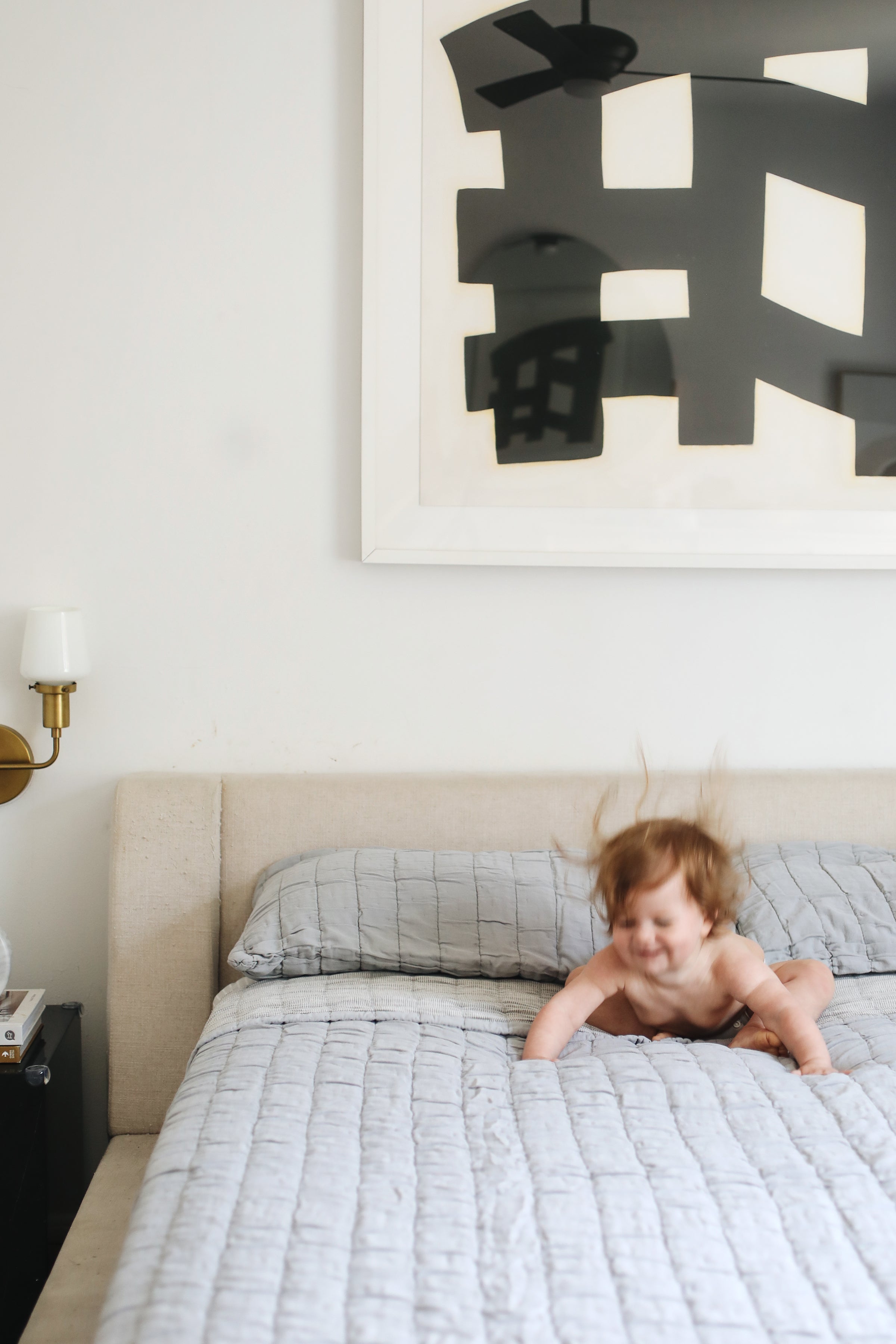 baby on a gray bed