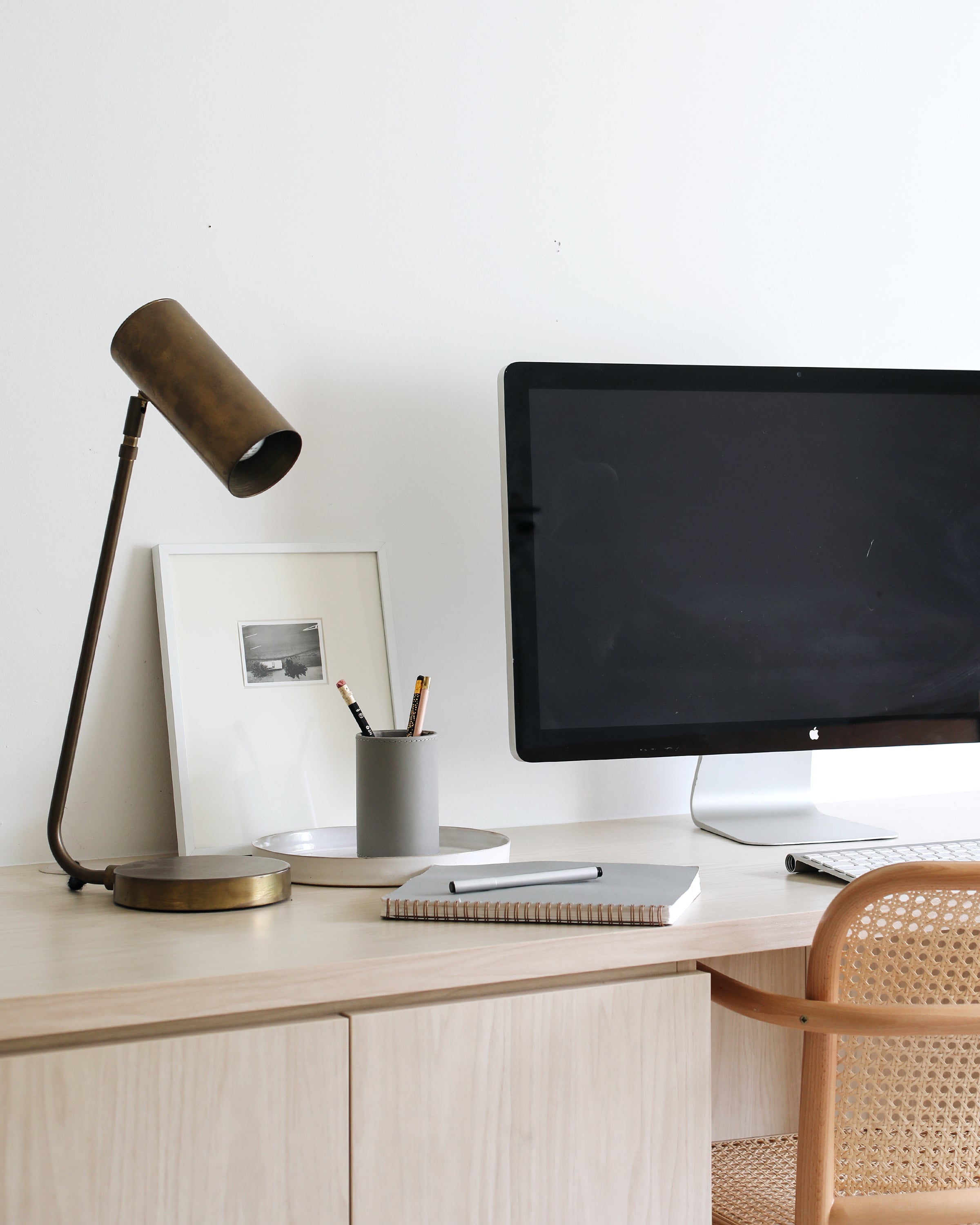 desk with a computer and a lamp on it