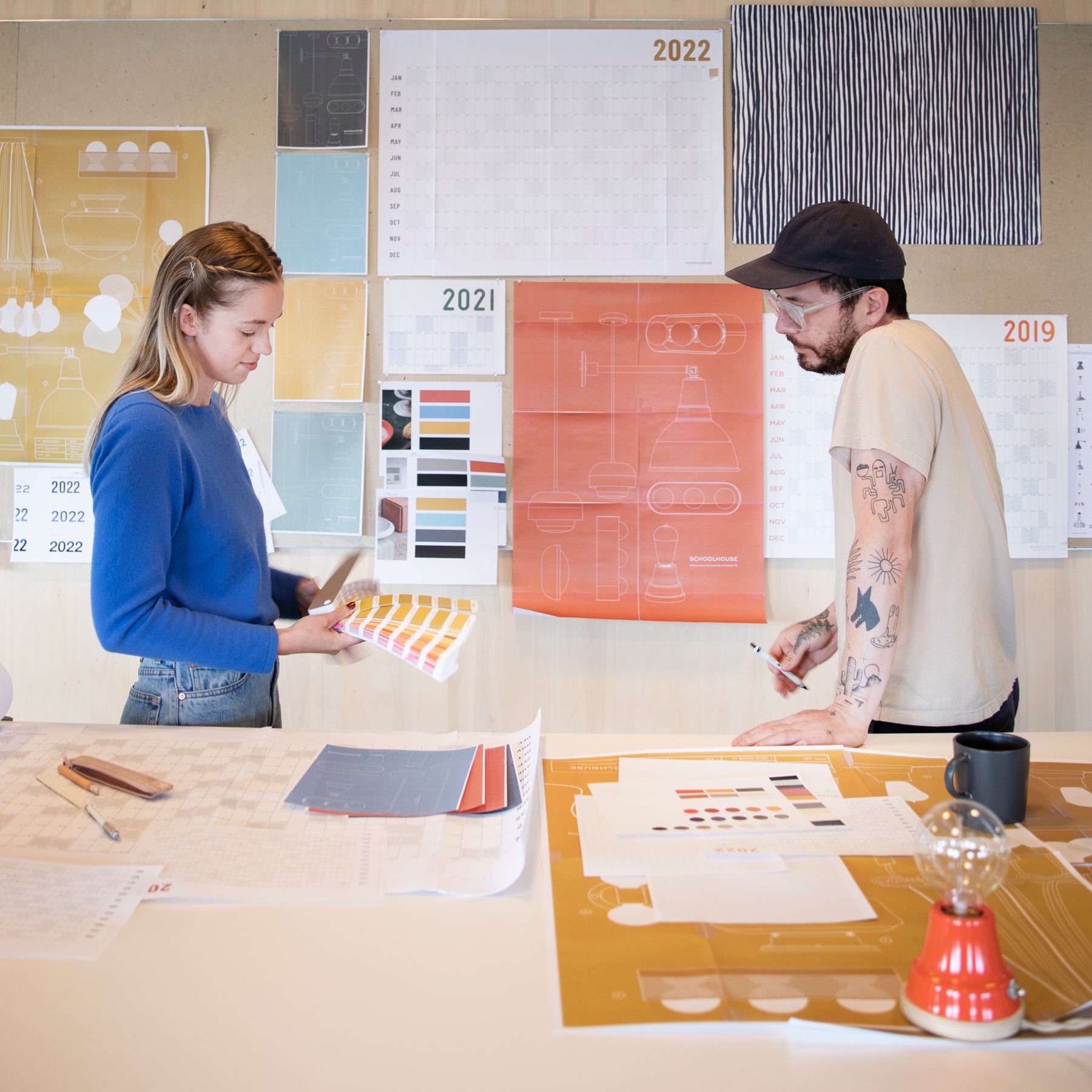 man and a woman standing at a table 