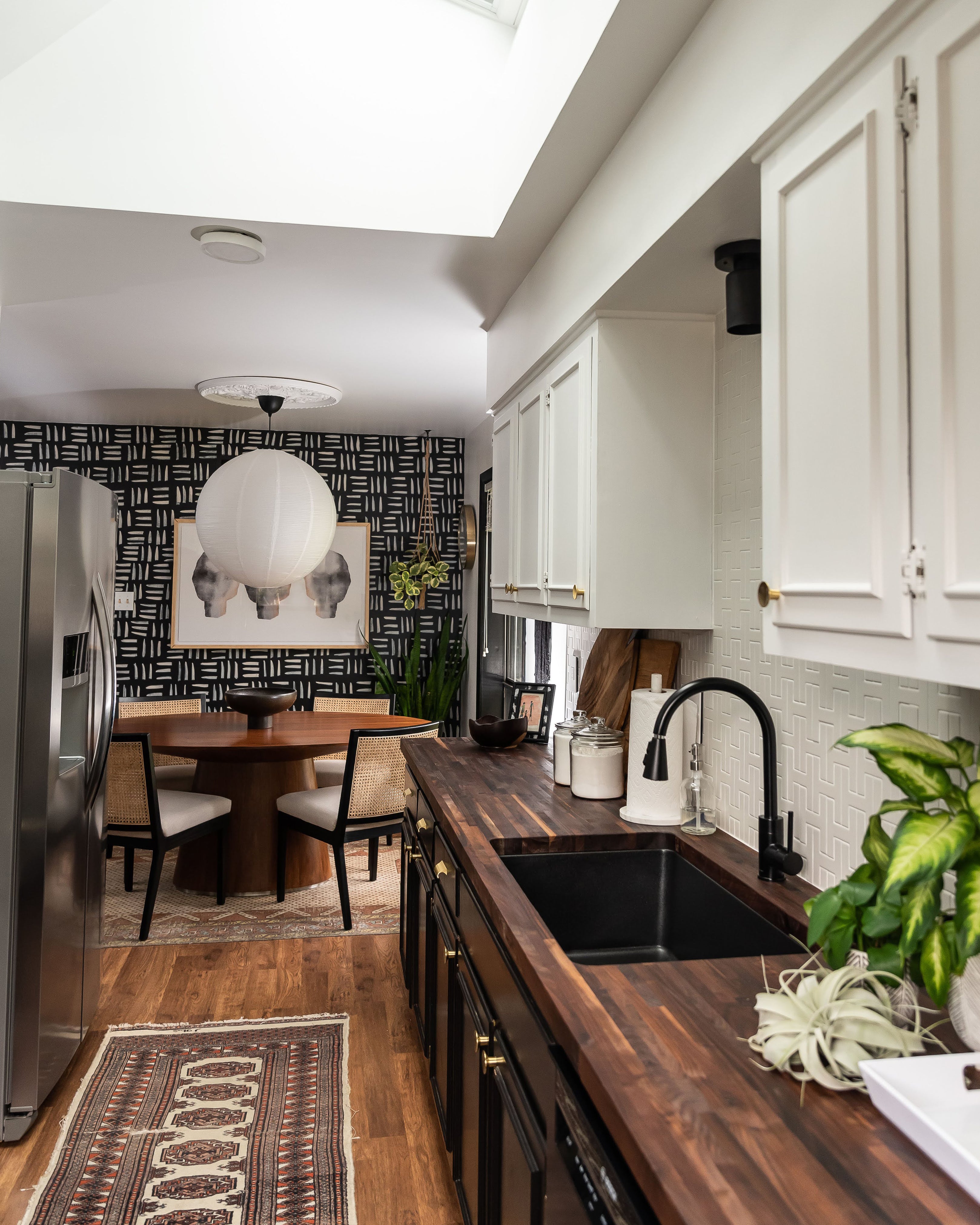 kitchen with a table and chairs in the background