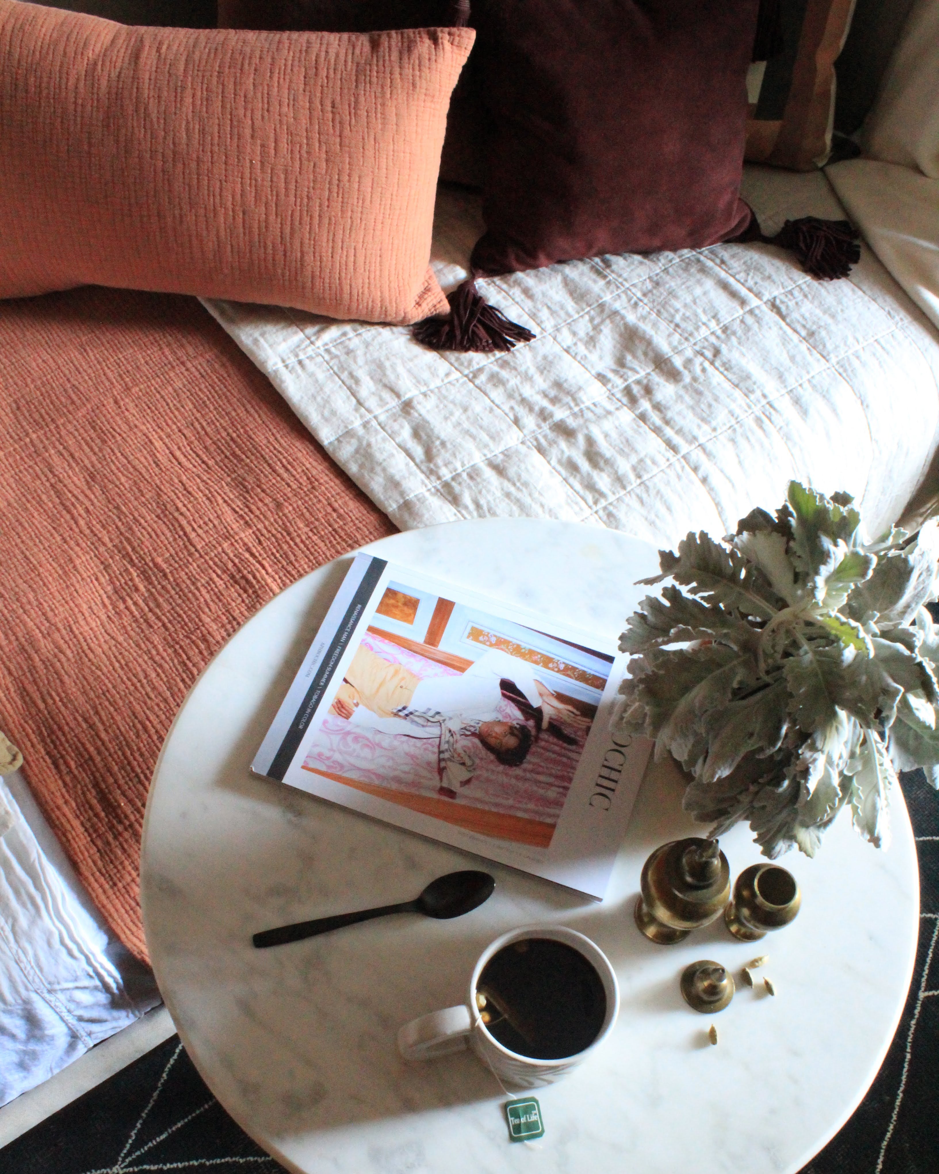 book and a cup of coffee on a round table 