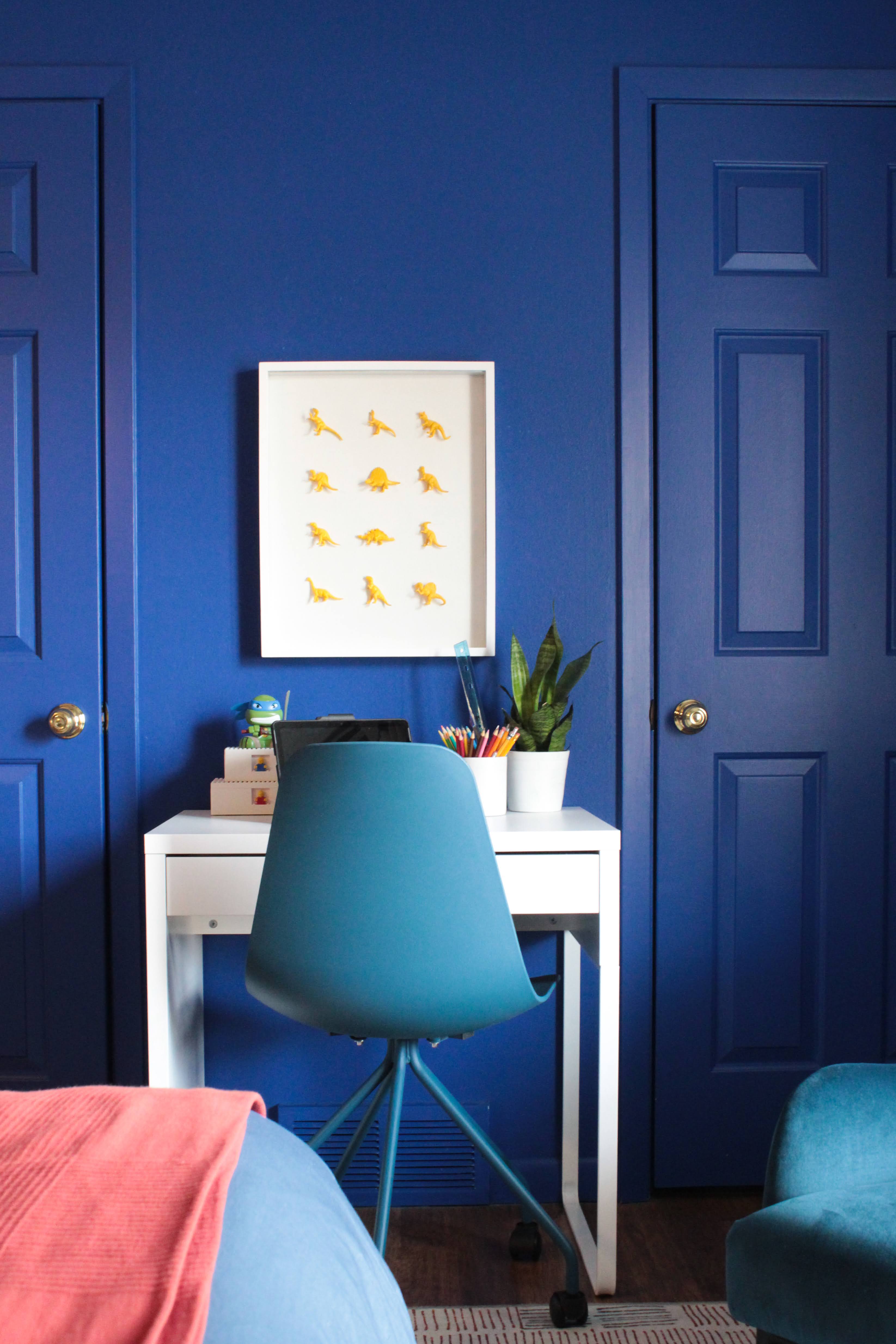 blue room with blue chair and white desk