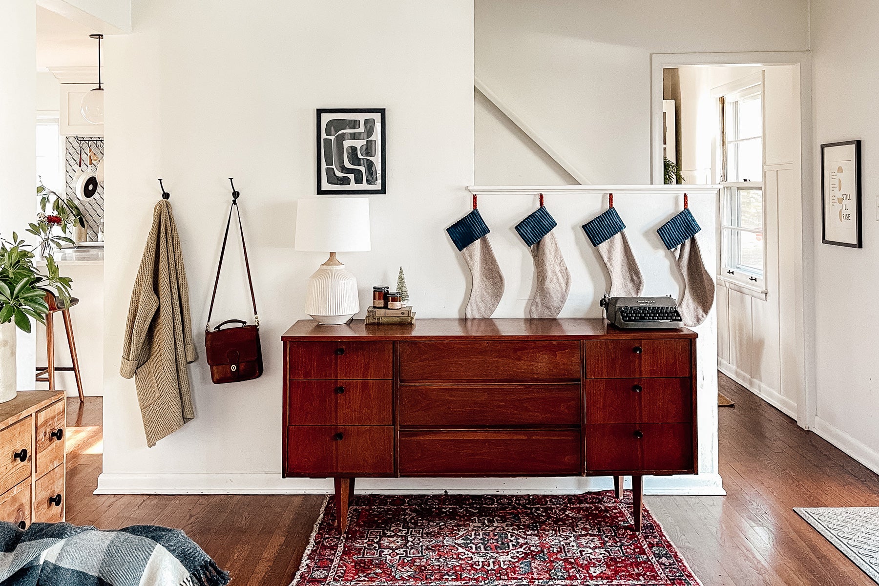 room with a dresser and a rug and stockings