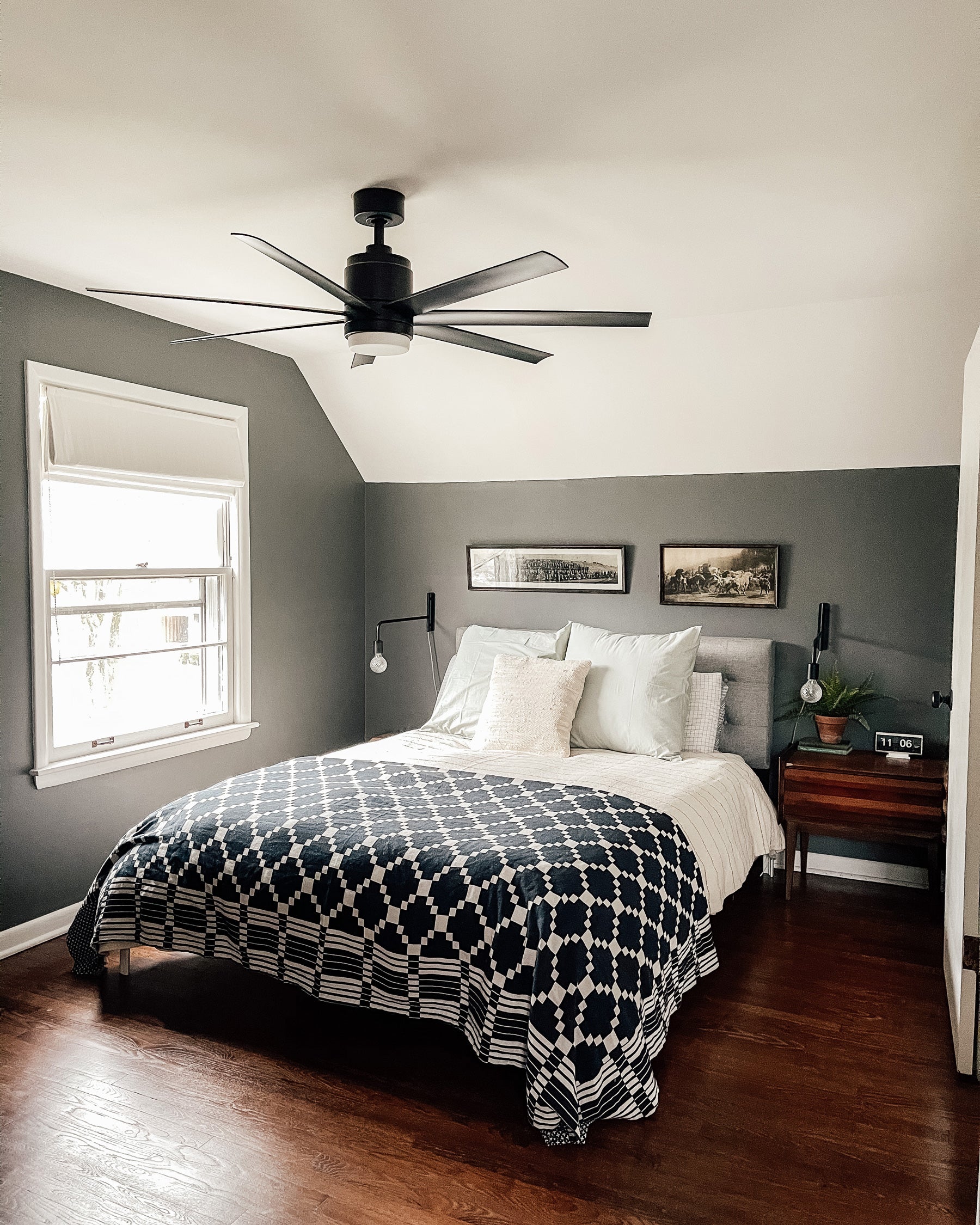 bedroom with a ceiling fan and a black and white bedspread