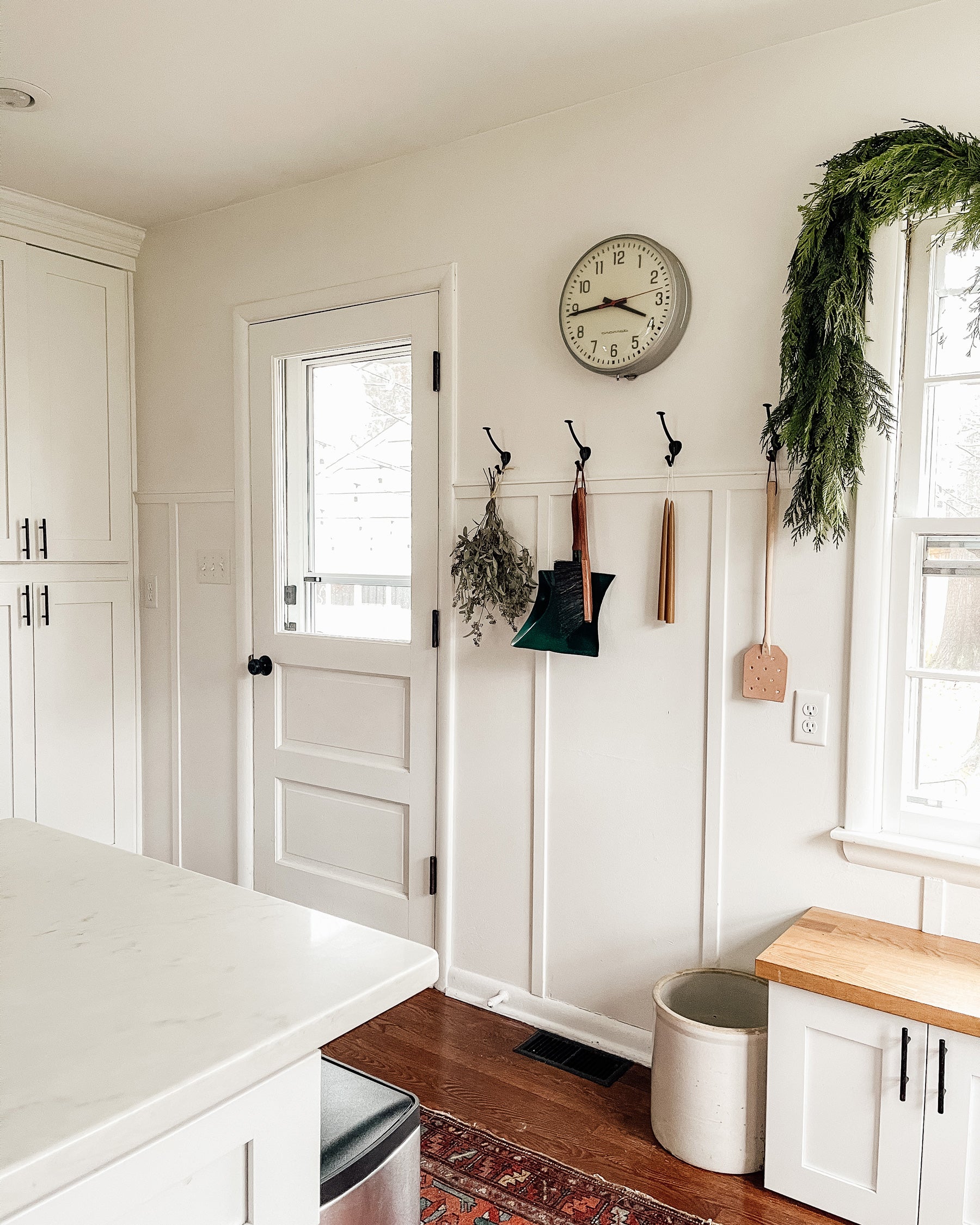 kitchen with a clock and hooks