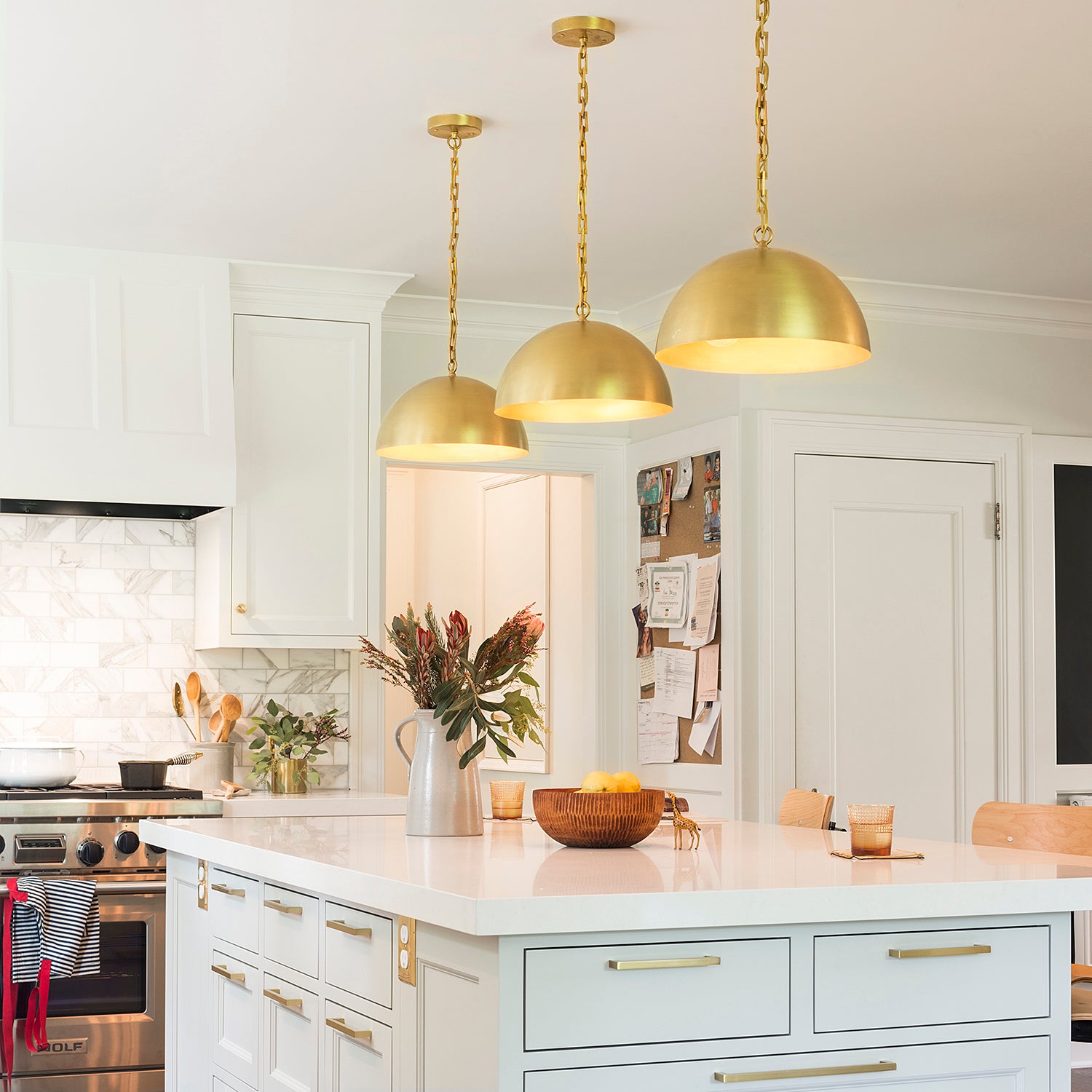 kitchen with white cabinets and gold ceiling light fixtures