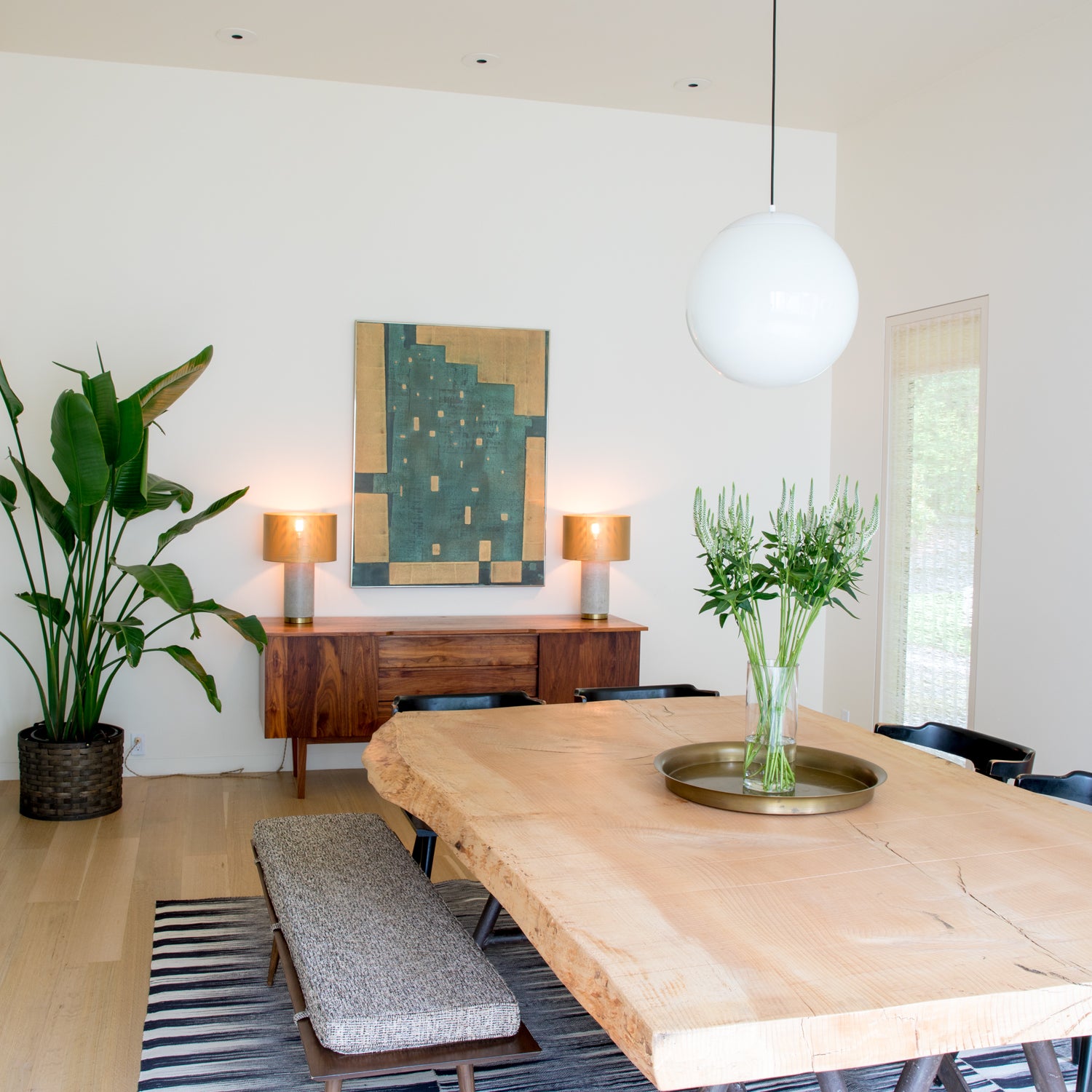 dining room table with white orb light fixture