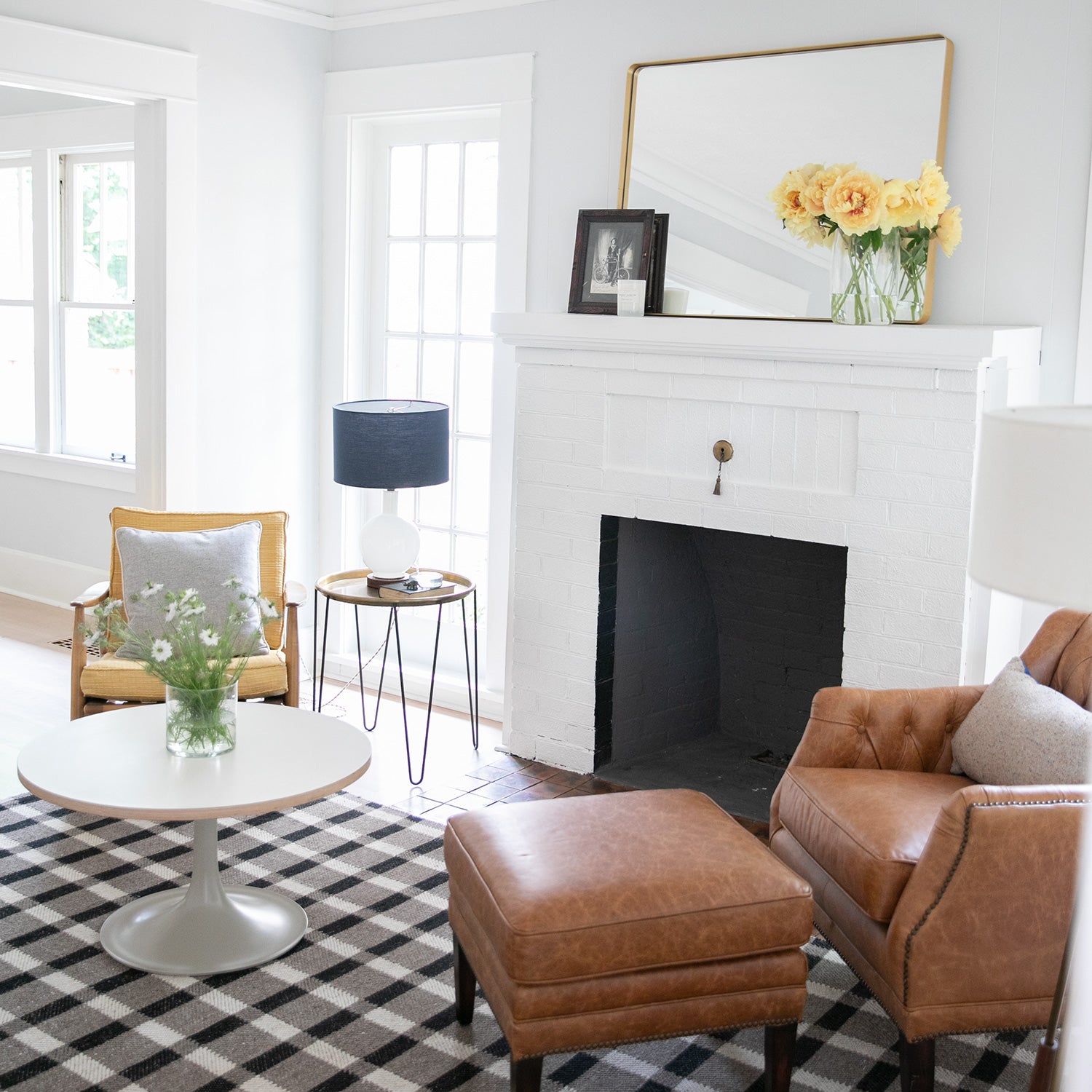 living room with a fireplace and a brown armchair and a brown ottoman