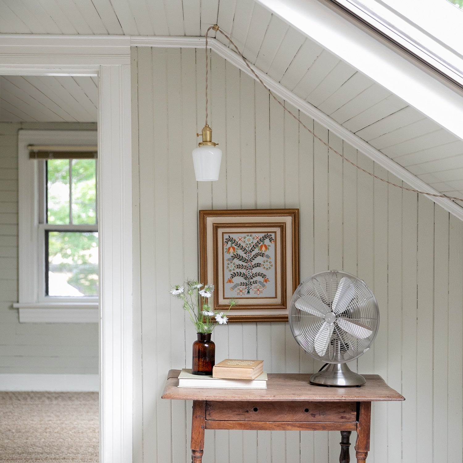 room with a fan and a table