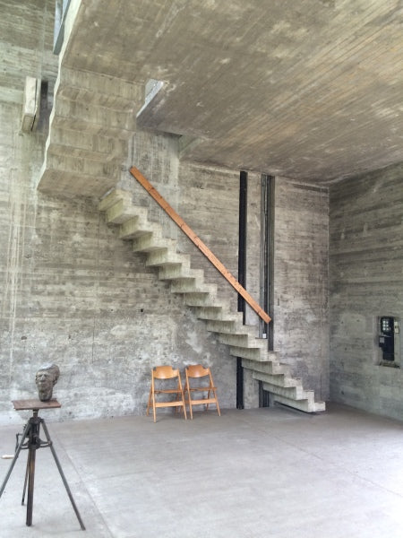 staircase in room with concrete walls