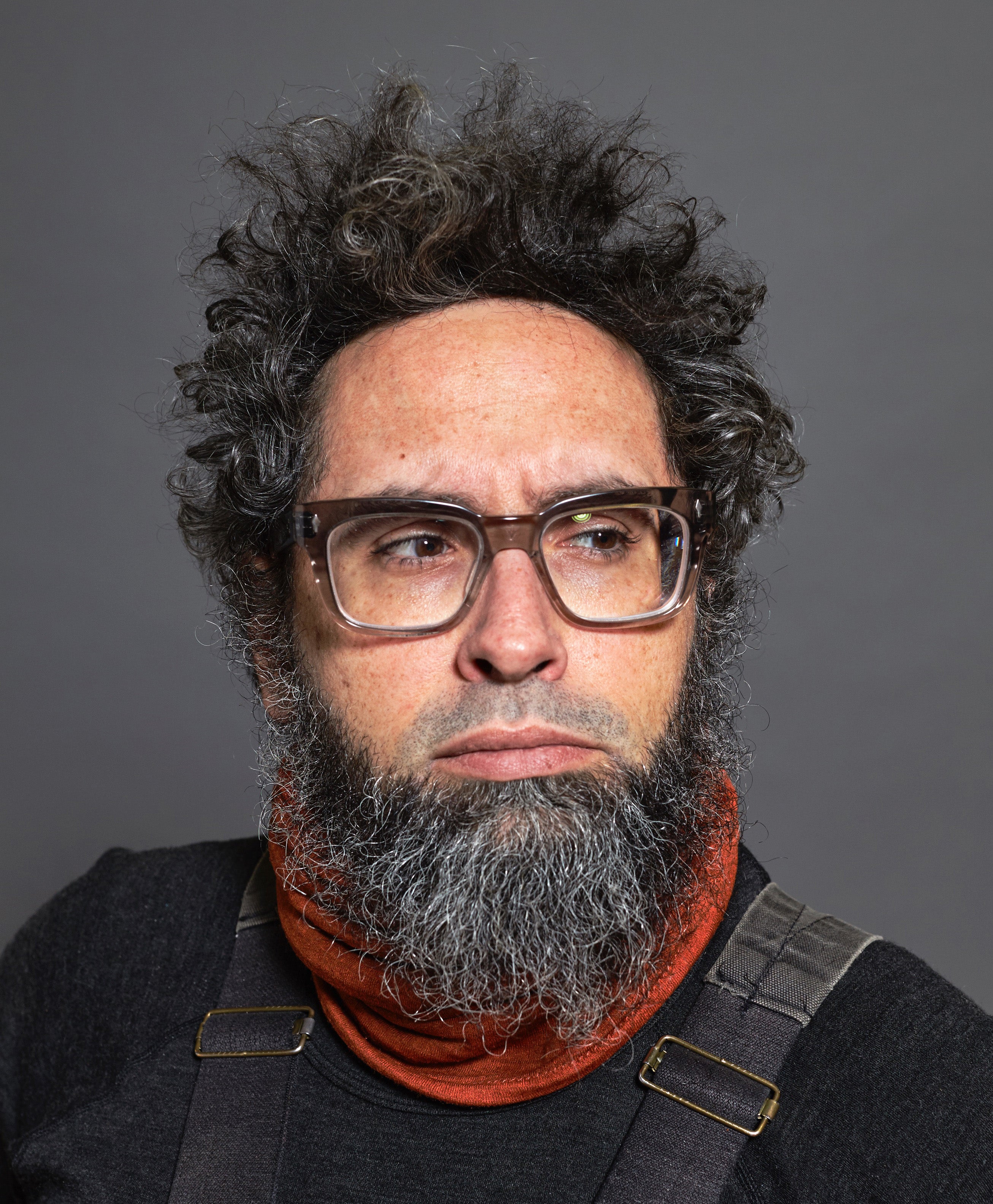 man with curly hair and glasses and beard