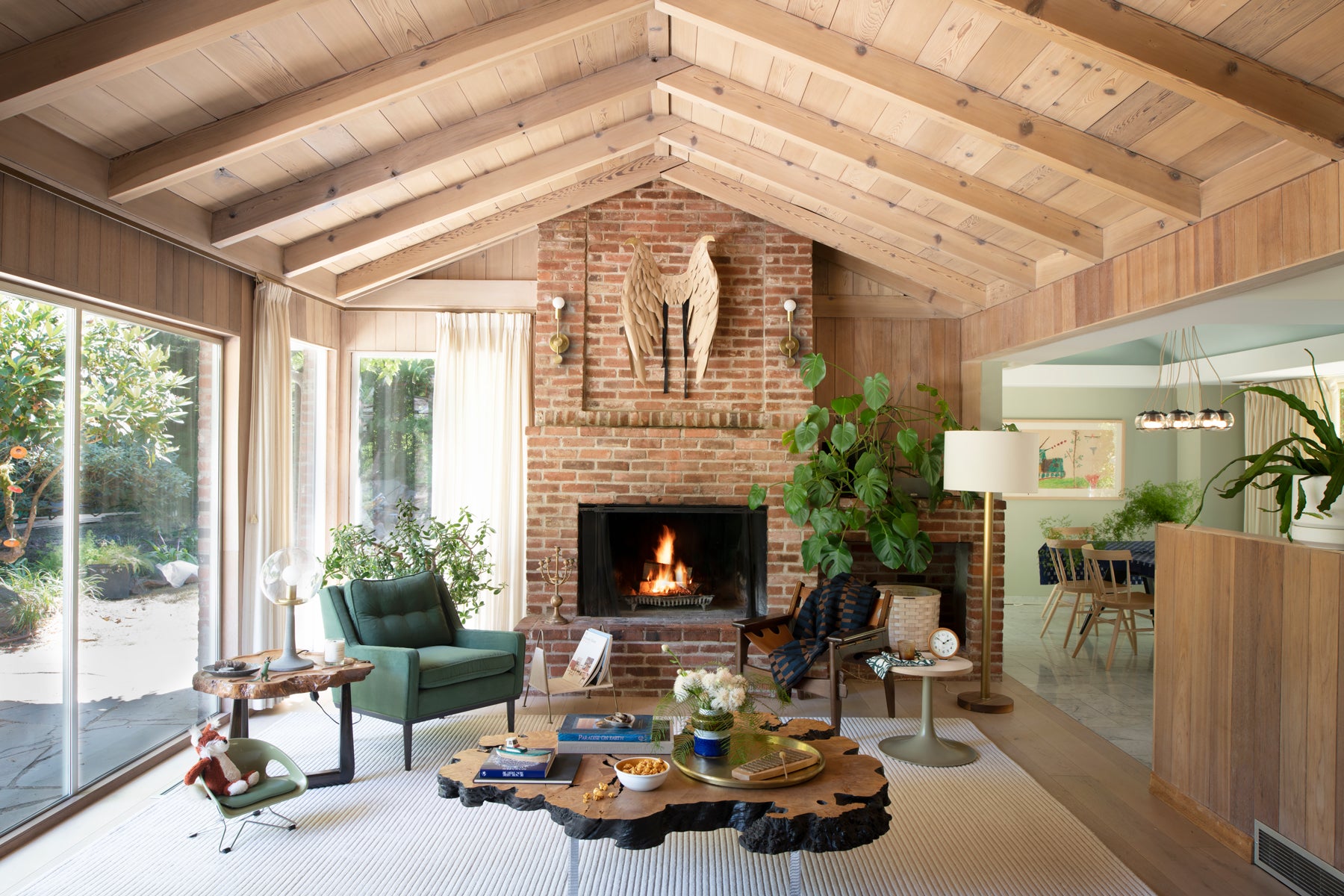 living room with a fireplace and a green armchair