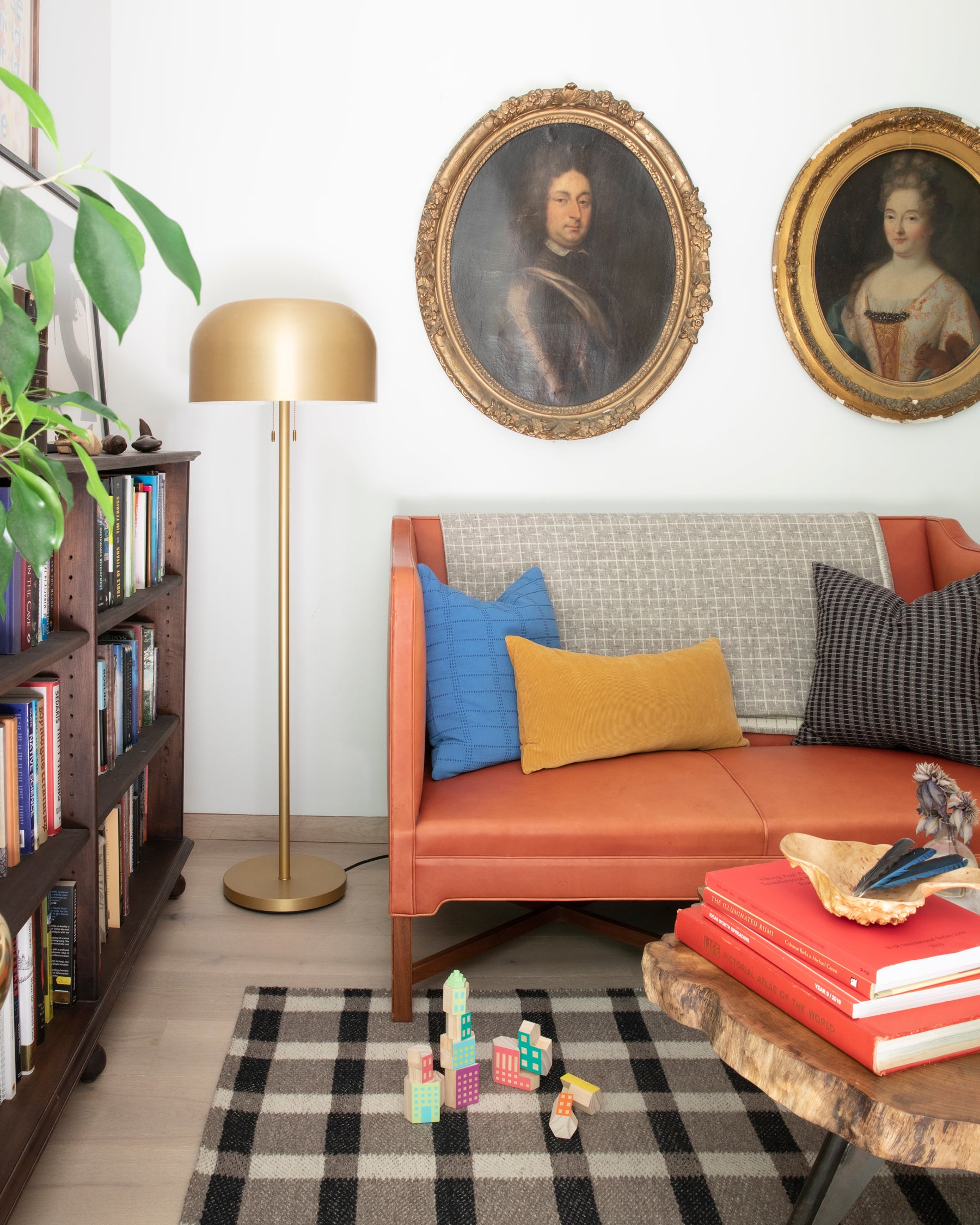 living room with a couch and a gold floor lamp