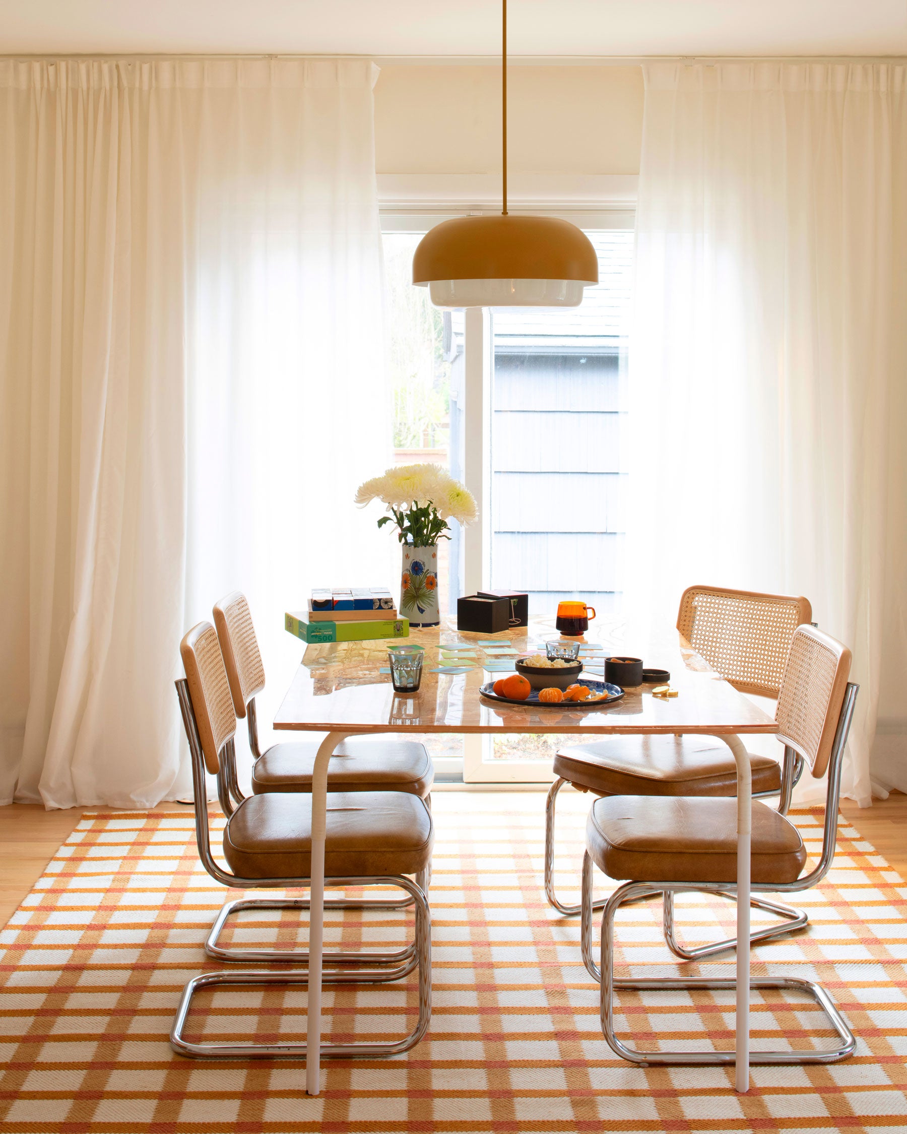 table with chairs and a hanging light fixture