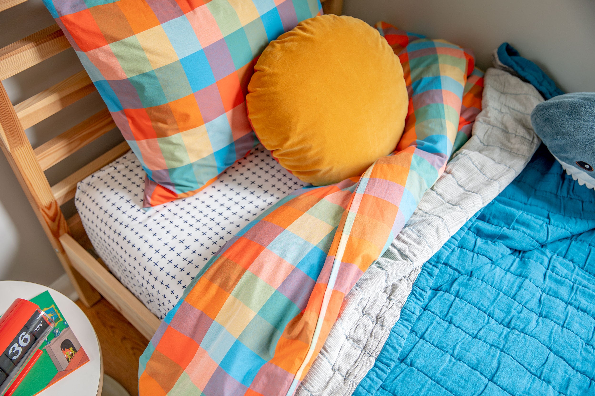 colorful pillows on a blue bed