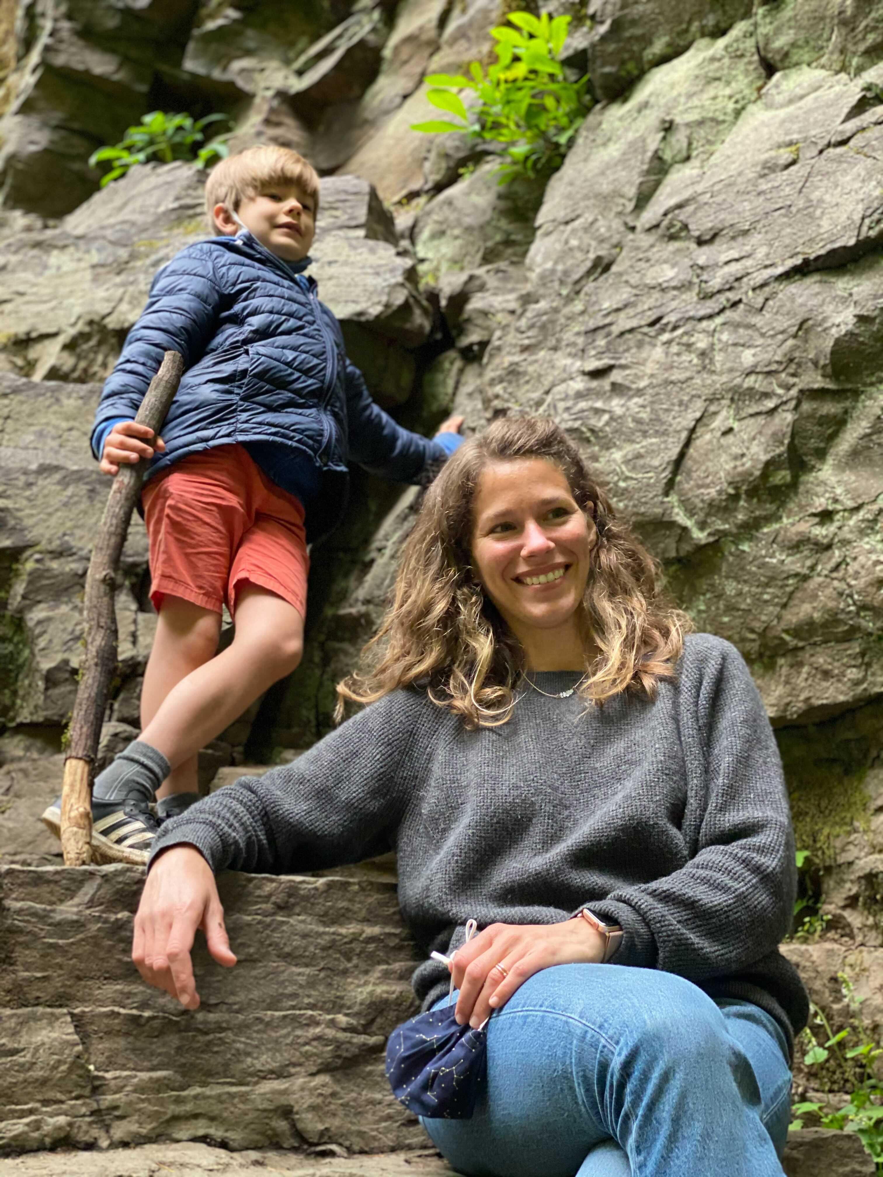 adult woman and boy on rocks