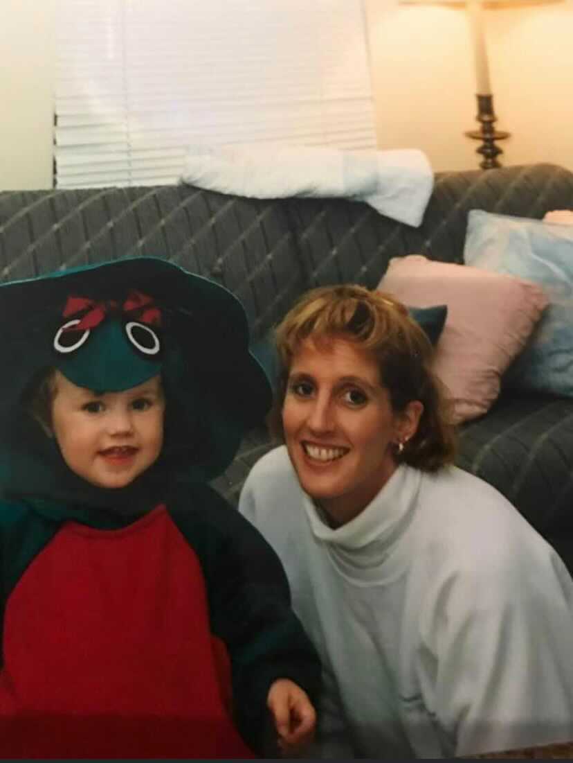 baby in a costume next to an adult smiling for the camera