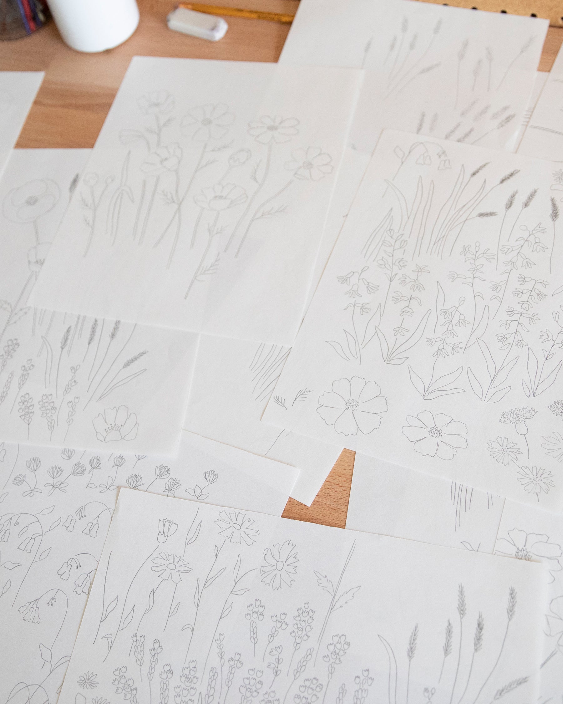 papers with drawings on them on a table