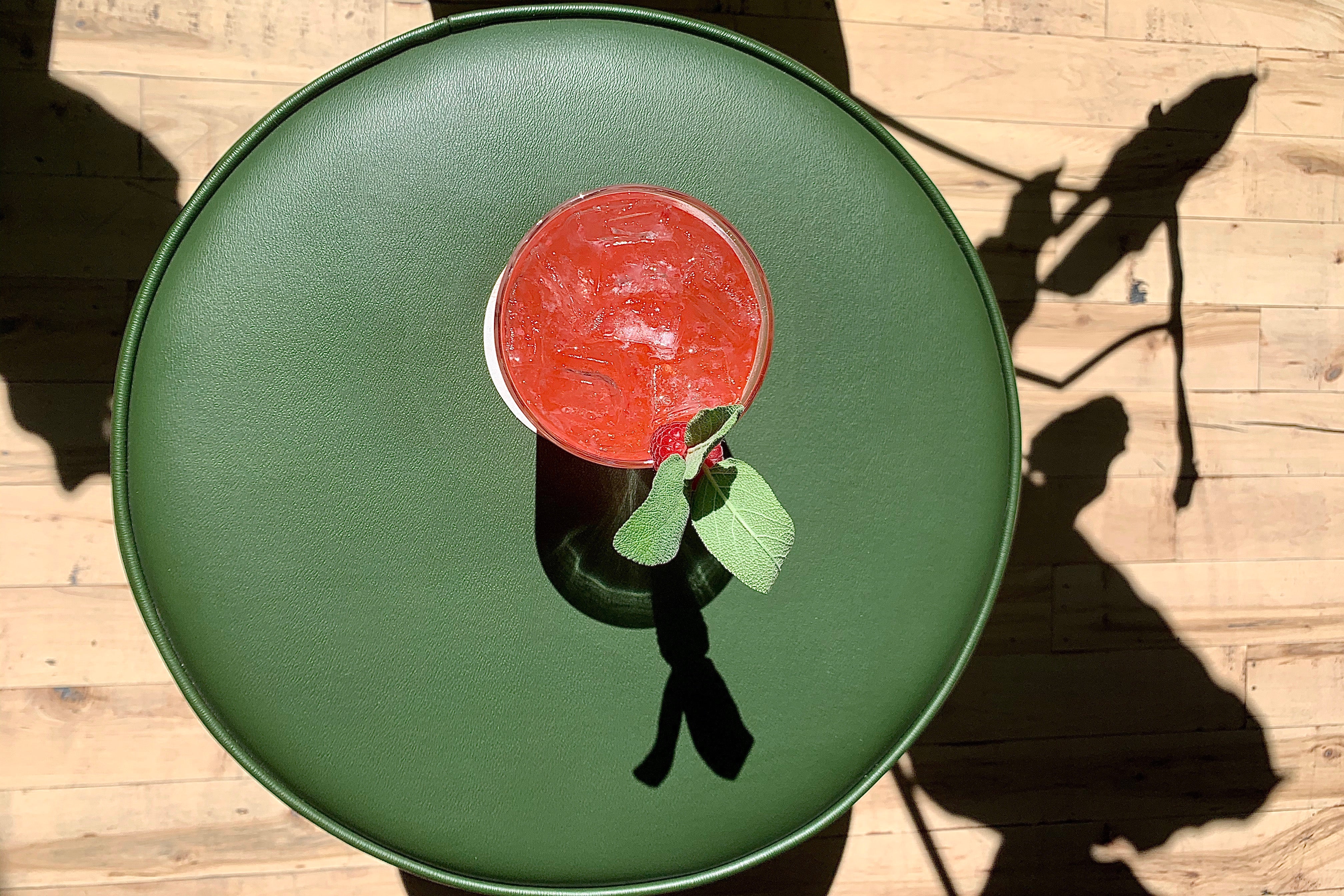 red drink on a green round table