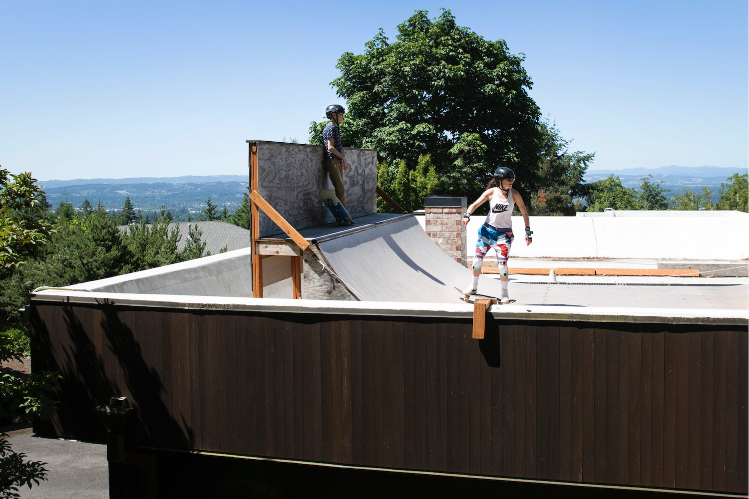 couple of people skating on a ramp