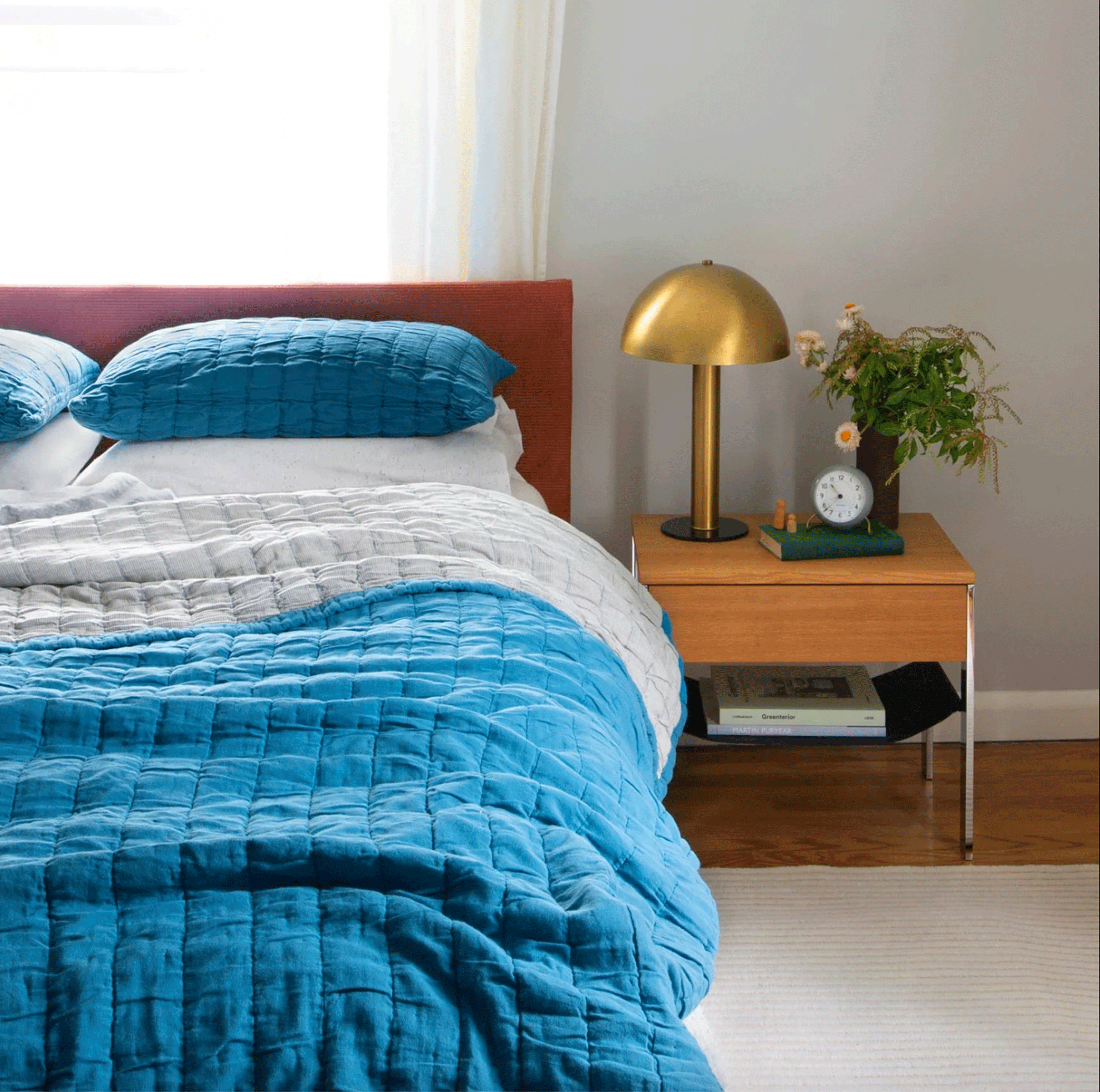 A bed with a blue comforter