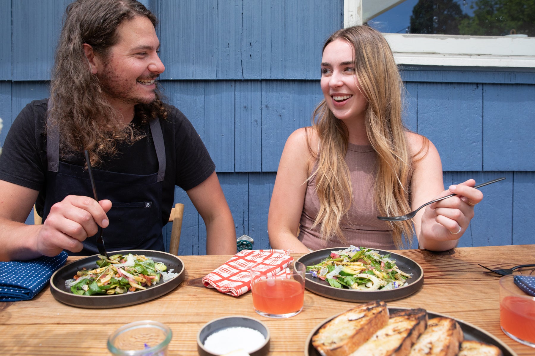 man and a woman eating at a table