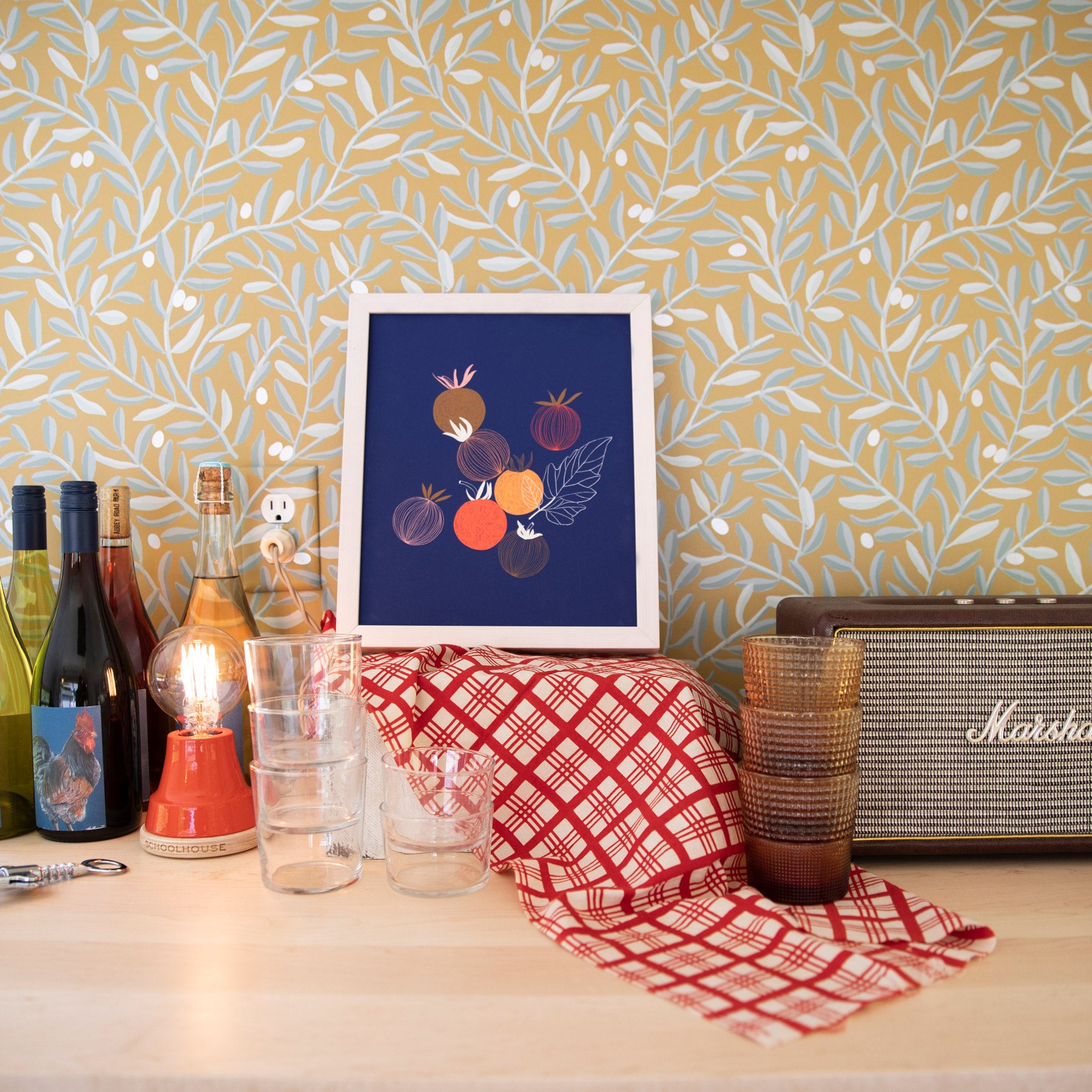 table with bottles and a painting on it