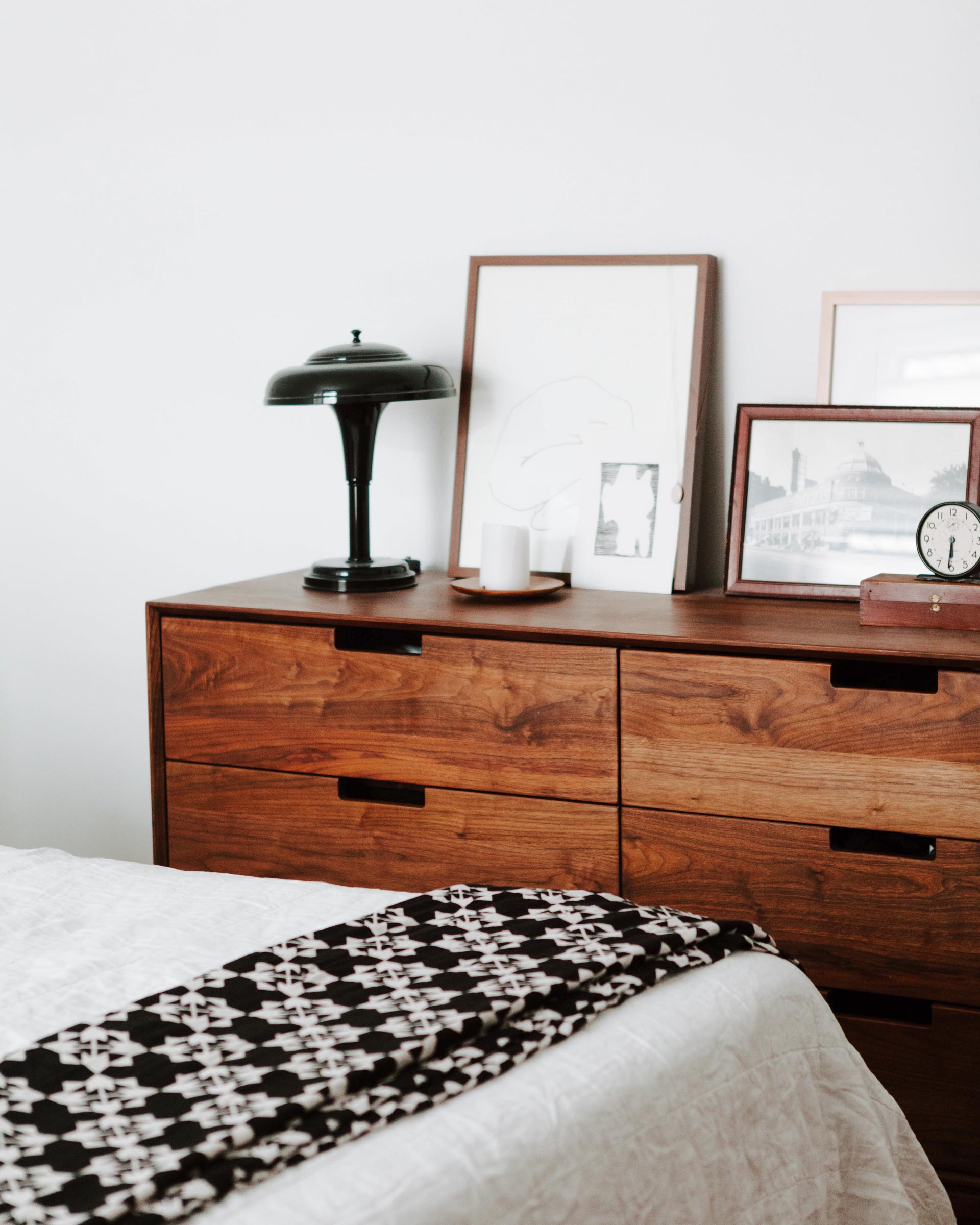 The Graduate Lamp in black on a credenza. 