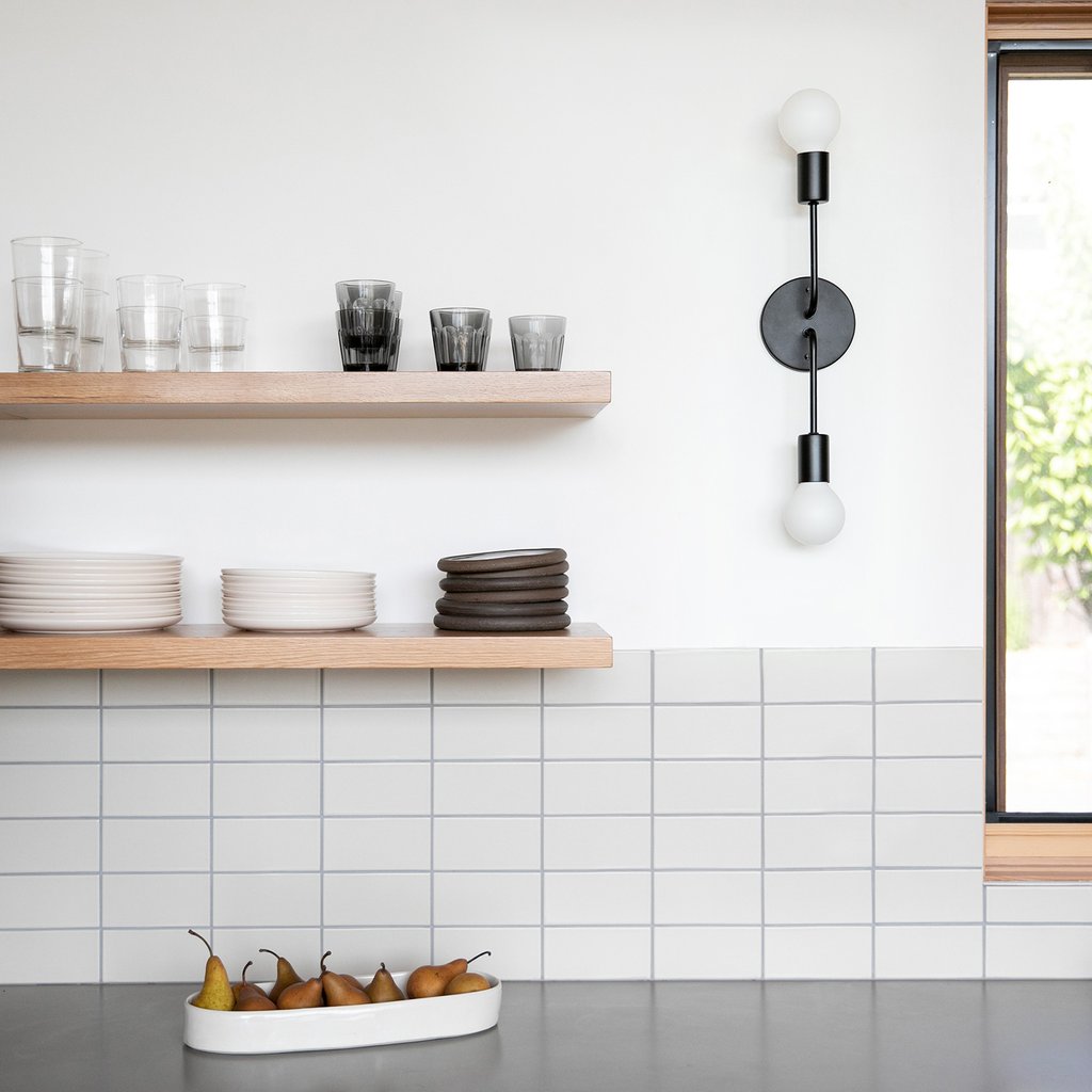 kitchen with a white tile wall and wooden shelves