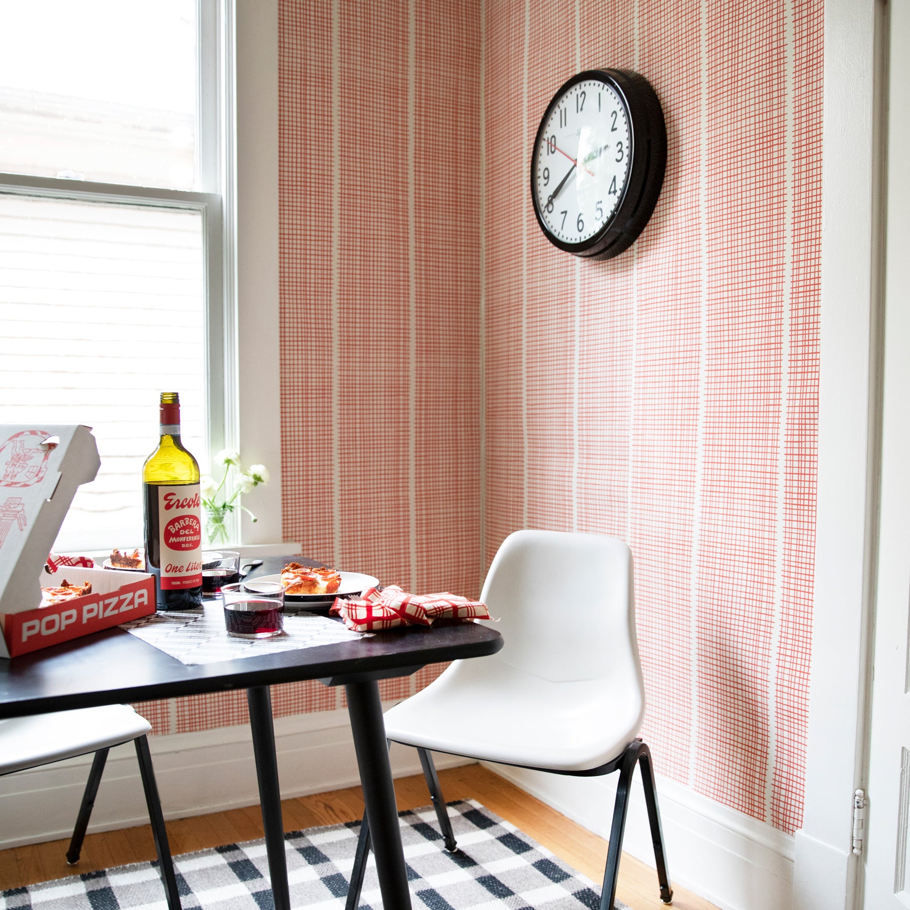 table with food on it and black clock on a wall