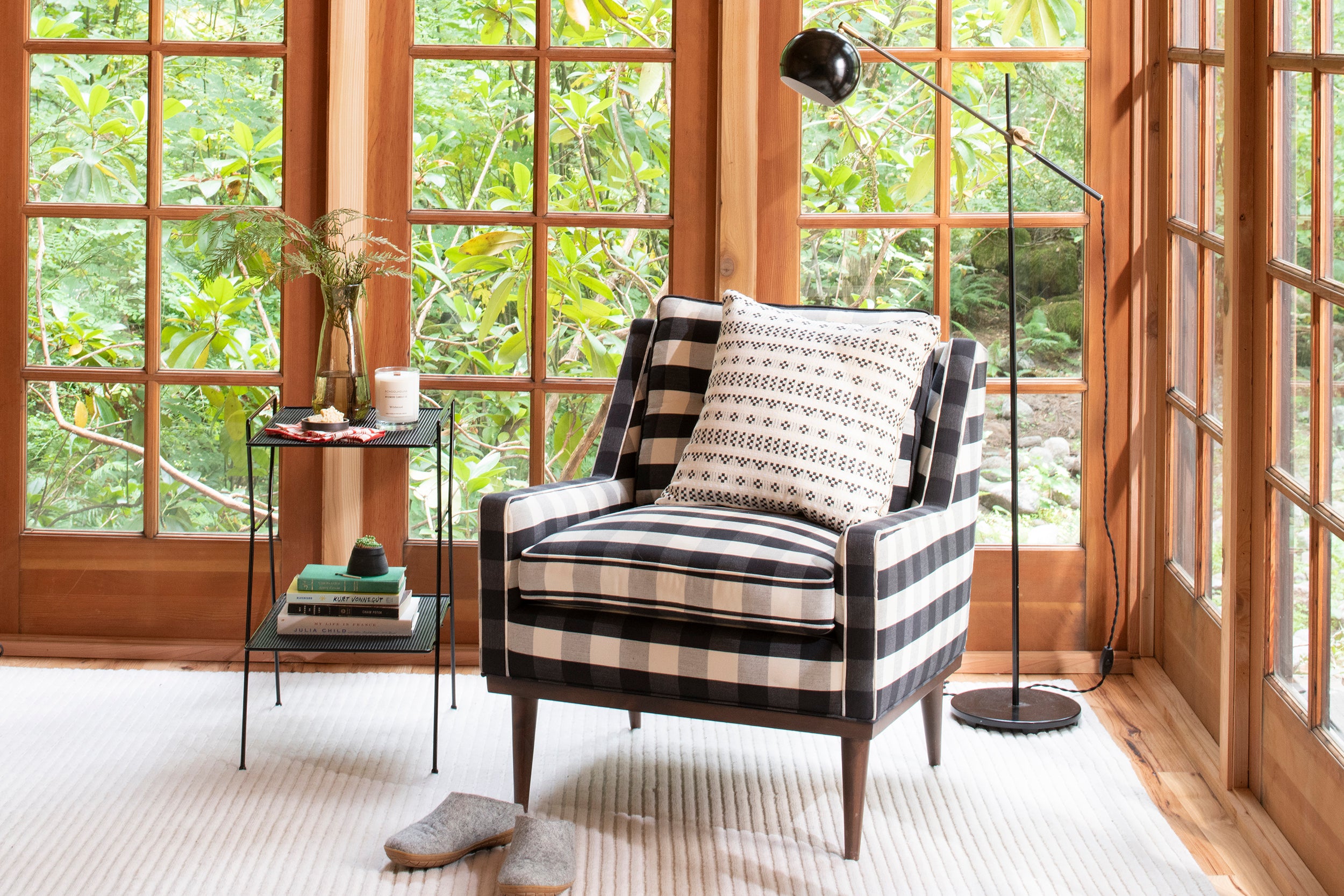 chair in a room with large windows and black floor lamp