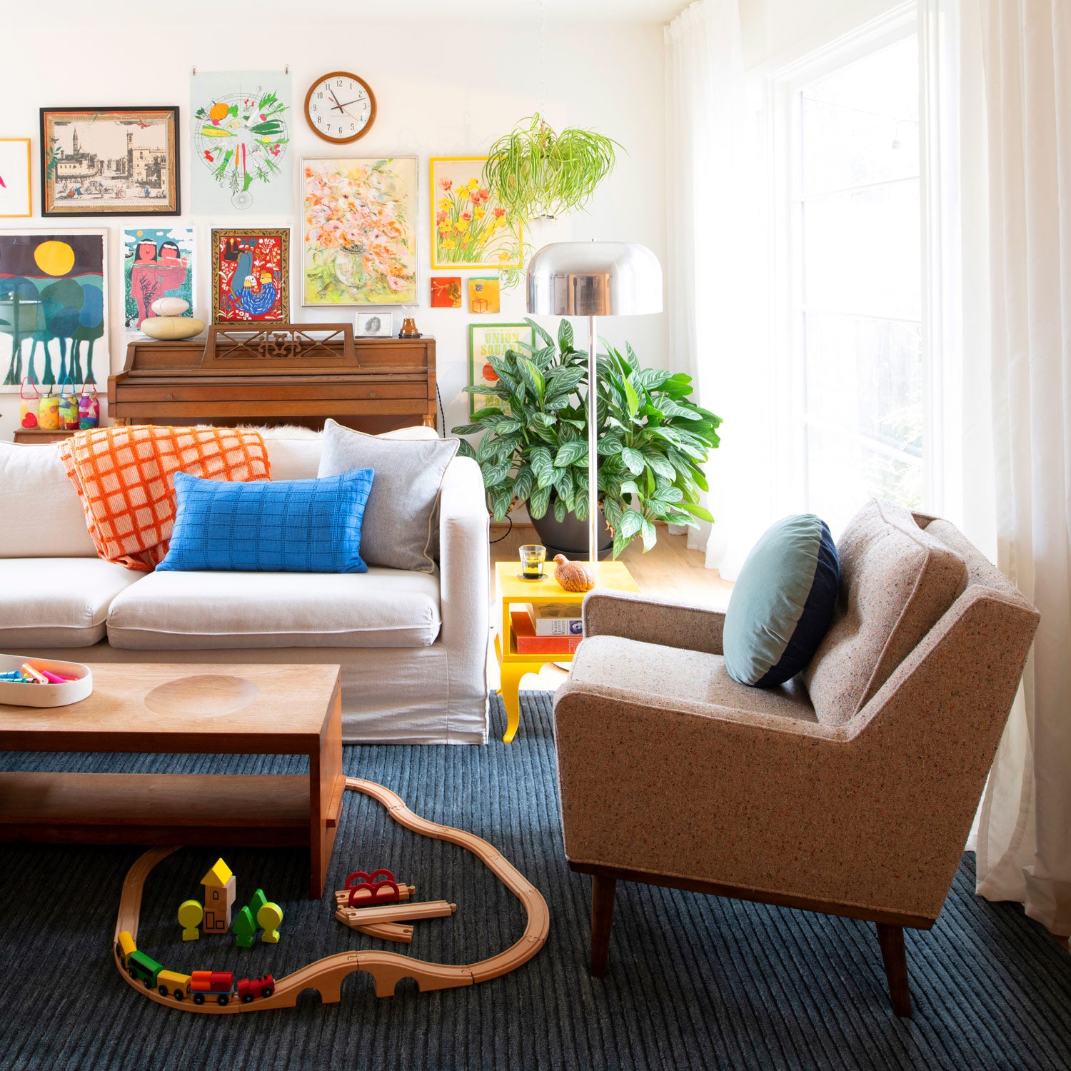 living room with a couch and a coffee table and a silver floor lamp