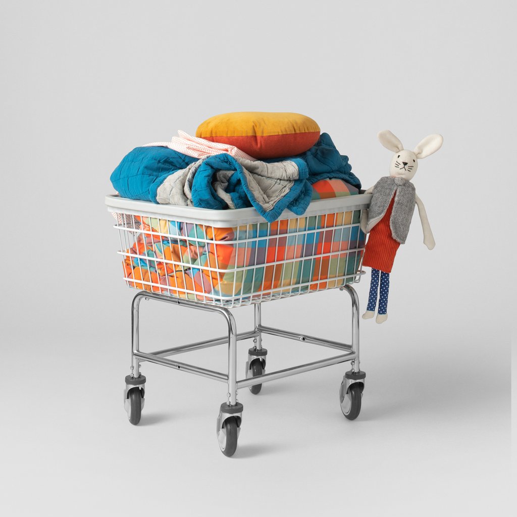 white bunny plush and pillows in a shopping cart