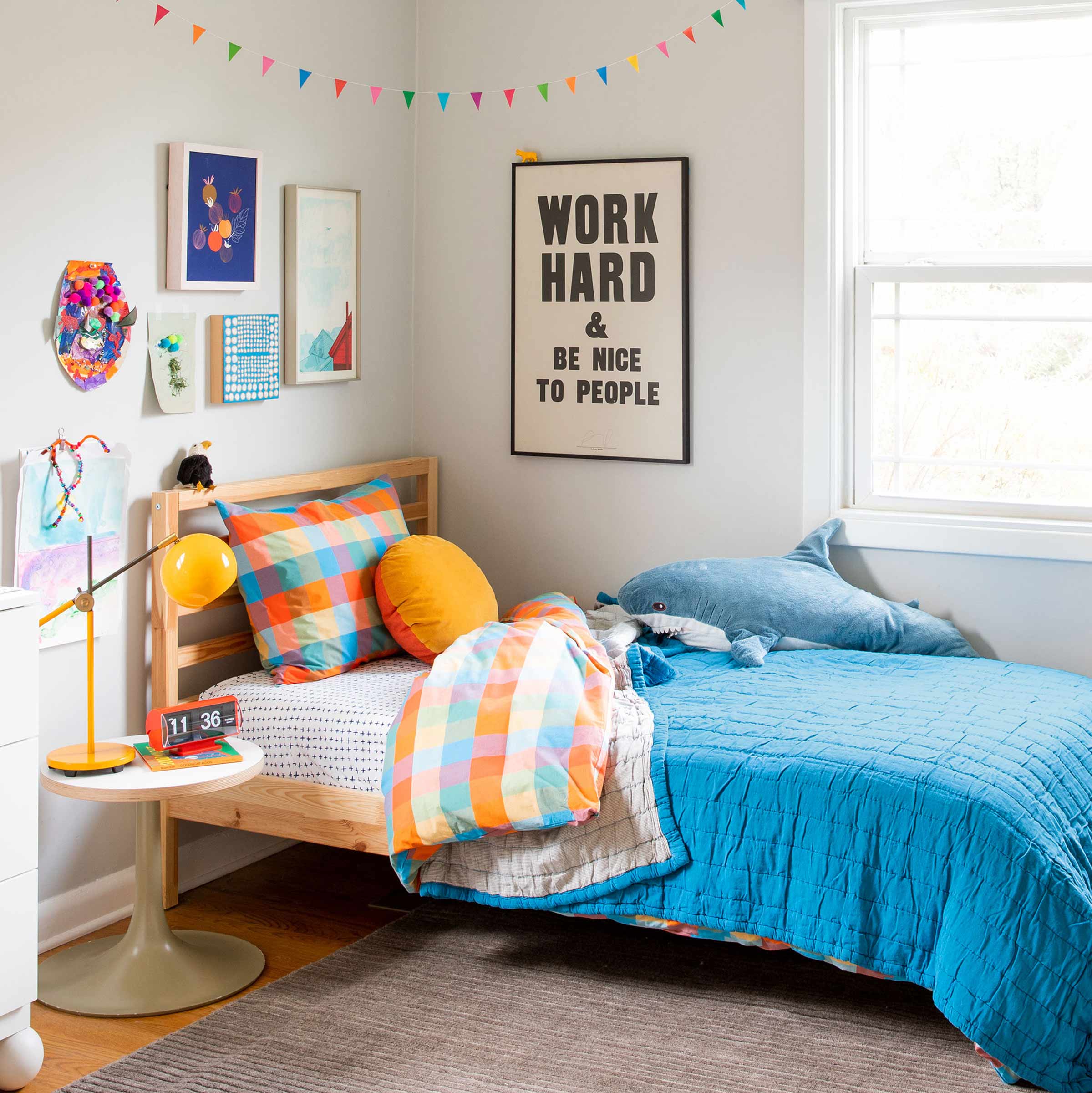A bright kid's bed with plaid bedding.